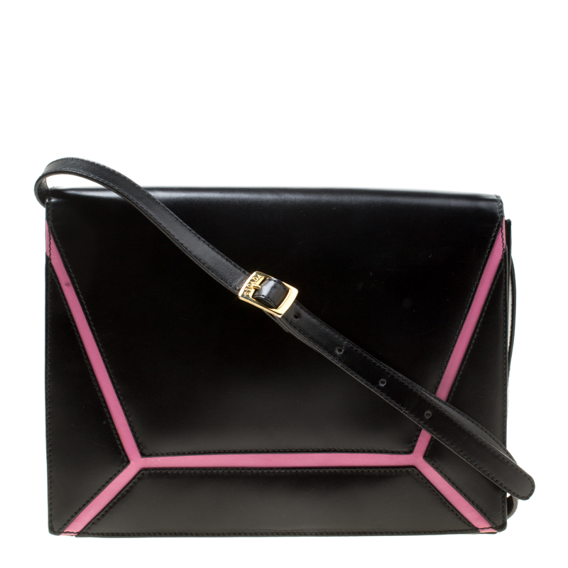 Let your audience be dazzled when you make an impressive style statement with this contemporary bag by Escada The black and pink bag is crafted from leather and features a front flap closure that opens to a spacious interior housing an open compartment and a zip pocket. It flaunts an adjustable shoulder strap and is sure to add an instant charm to your outfits. Grab it right away