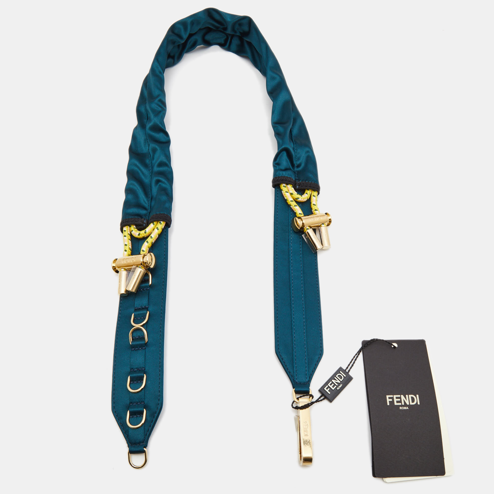 Enhance your style with the Fendi shoulder strap. Crafted with luxurious satin and adorned with a teal shade this exquisite accessory adds a touch of elegance and sophistication to your handbag making it a must have for fashion enthusiasts.