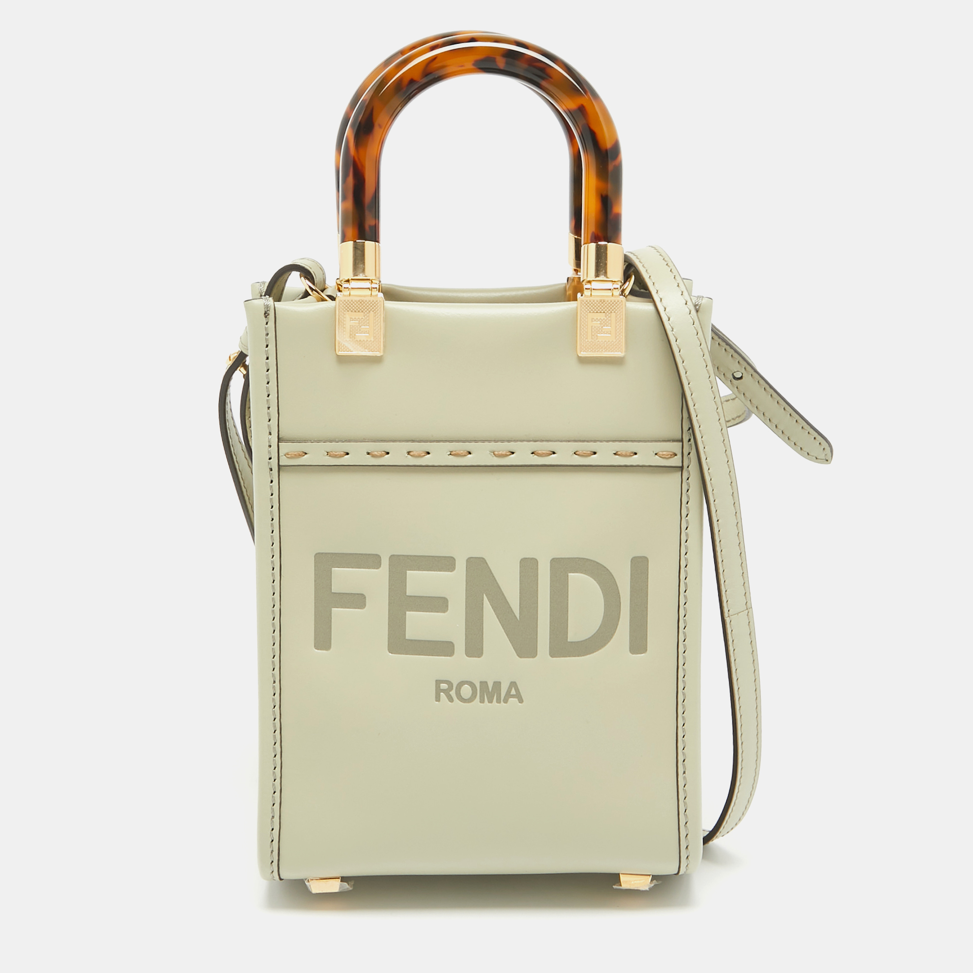 Crafted from luxurious green leather the Fendi Sunshine tote exudes effortless glamour. Its compact size makes it perfect for everyday essentials while the sleek design and subtle Fendi logo add a touch of understated elegance. Carry it with confidence and style for a chic finishing touch to any ensemble.
