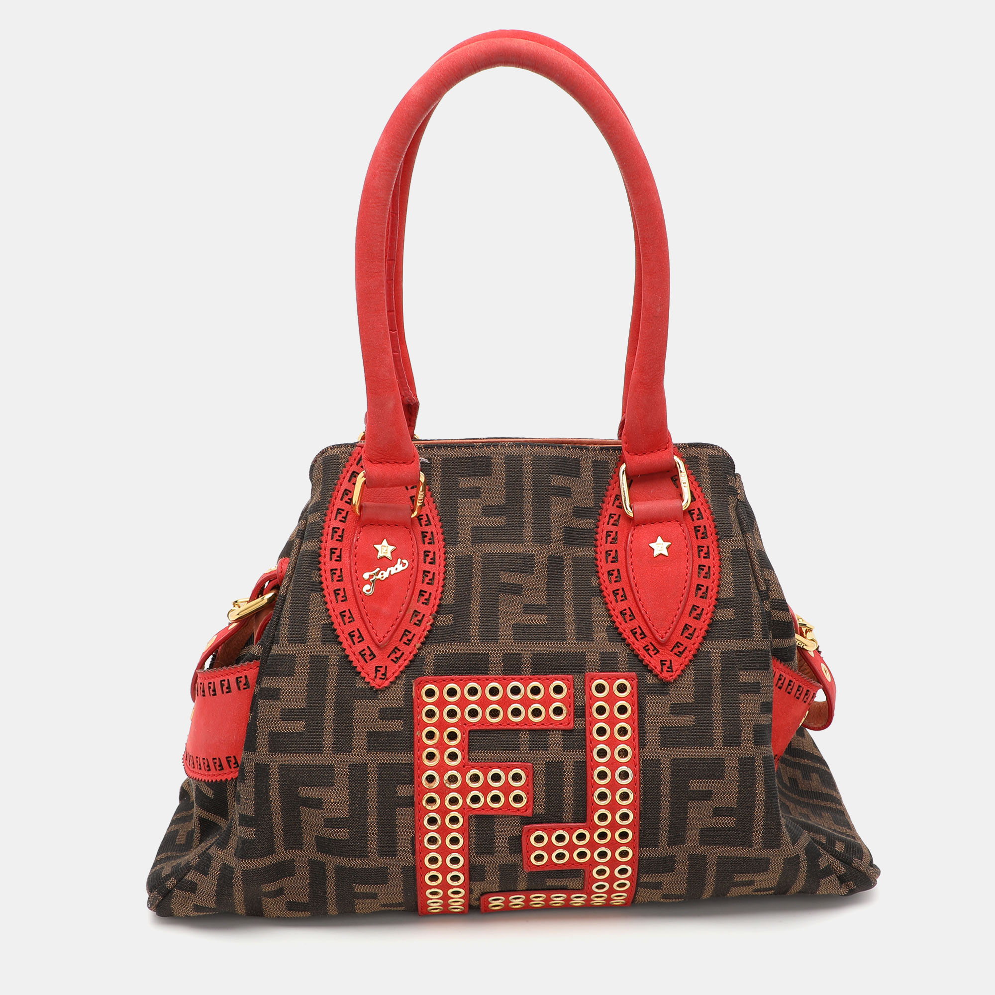 This Chef De Jour bag from the house of Fendi is designed in a chic brown Zucca canvas body and detailed with studs on the FF logo making it a statement piece. It comes topped with two rolled top handles. The spacious fabric lined interior has a zipper wall pocket to stow little essentials. Style against off duty looks for a fashion forward look.