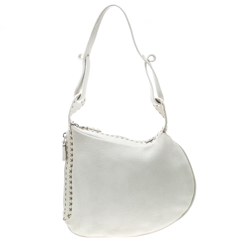 This stylish Oyster hobo is crafted to perfection with pebbled white leather in the shape of an oyster and is adorned with hand stitched details at the corners. The bag features an end to end shoulder strap and a top zipper closure. The bag opens to a suede lined interior spacious enough for all of your necessities that you carry with the unique quality and style of Fendi.