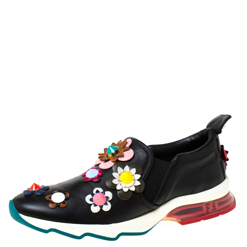 To accompany your attires with ease Fendi brings you this pair of sneakers that speak nothing but high style. Theyve been crafted from leather and designed with floral appliques. The sneakers are easy to slip on and they are elevated on comfortable soles.