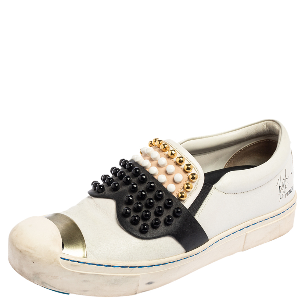 These stylish Karlito low top sneakers come from the iconic hose of Fendi. Crafted meticulously in Italy they are made from quality leather. These multicolor sneakers flaunt lovely hues and exude sophistication. They are styled with stud detailing on the vamps and contrasting stitch details. They are great to look at and even better to wear as they have comfortable leather lining insoles and rubber soles Leather sneakers are perfect for every casual occasion you have to attend. The uniqqueness of these Rubber sole sneakers is to die for.
