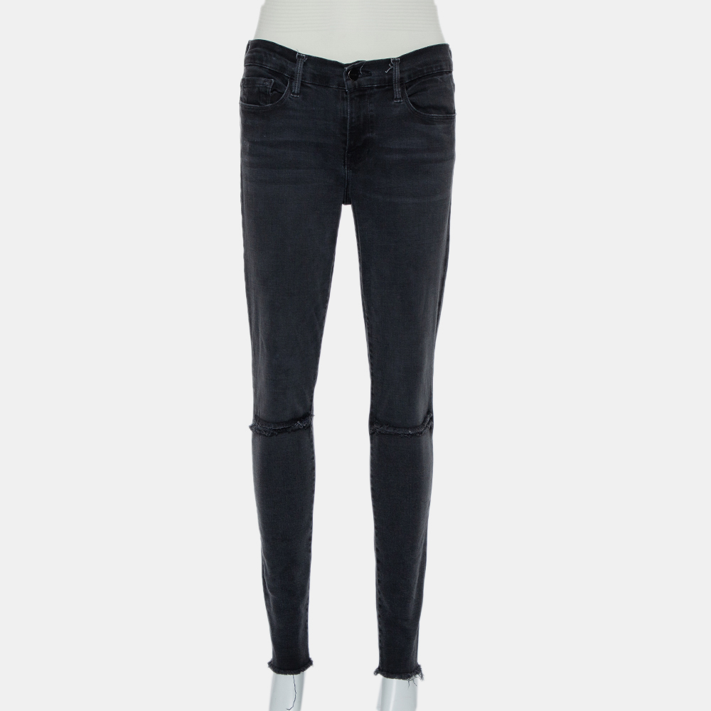 These skinny jeans from Frame are simply fabulous The black faded denim pair flaunts distressed and slashed knee details and comes equipped with belt loops a front button and zip fastening and five pockets. It will look great with simple T shirts and chic sneakers.