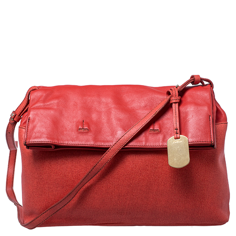 This lovely bag by Furla will add that pop of color to all your outfits. Crafted from leather this shoulder bag comes in a shade of orange and features a fold over silhouette. The fabric lined interior is spacious enough to carry all your essentials. The bag is held by a long strap and is equipped with gold tone hardware.