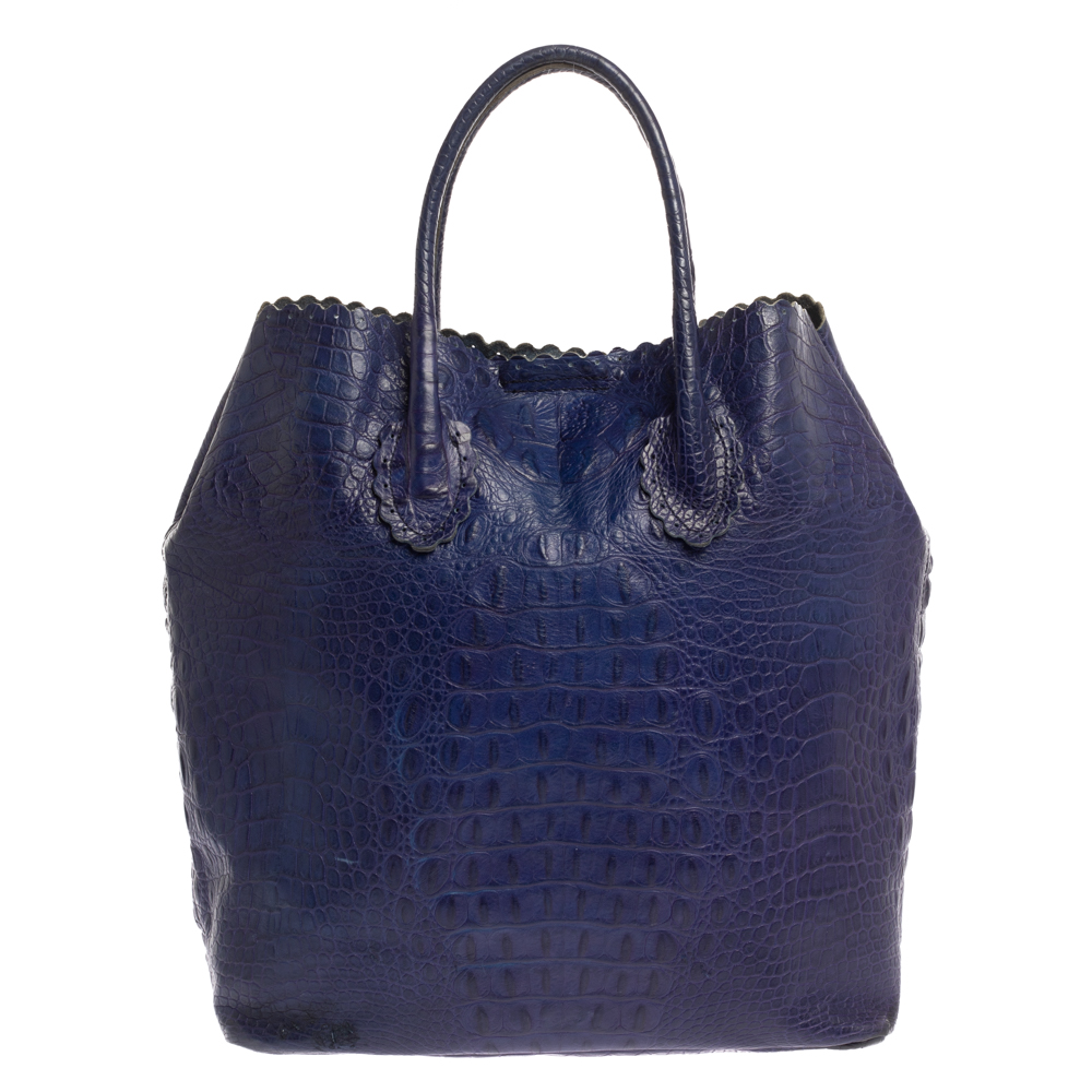 Finely crafted from croc embossed leather and shining with luxury is this beautiful tote by Furla. It comes with a suede fabric interior to store your essentials and two handles on top. You truly deserve to have a well made creation like this one.