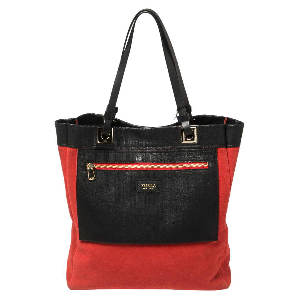 Get set to grab a lot of compliments every time you carry this tote from Furla The creation is crafted from textured leather and suede and features dual handle straps the brand label and a zip pocket to the front. It opens to a spacious interior that can easily hold all your daily essentials. It is one piece that definitely needs to be on your wishlist