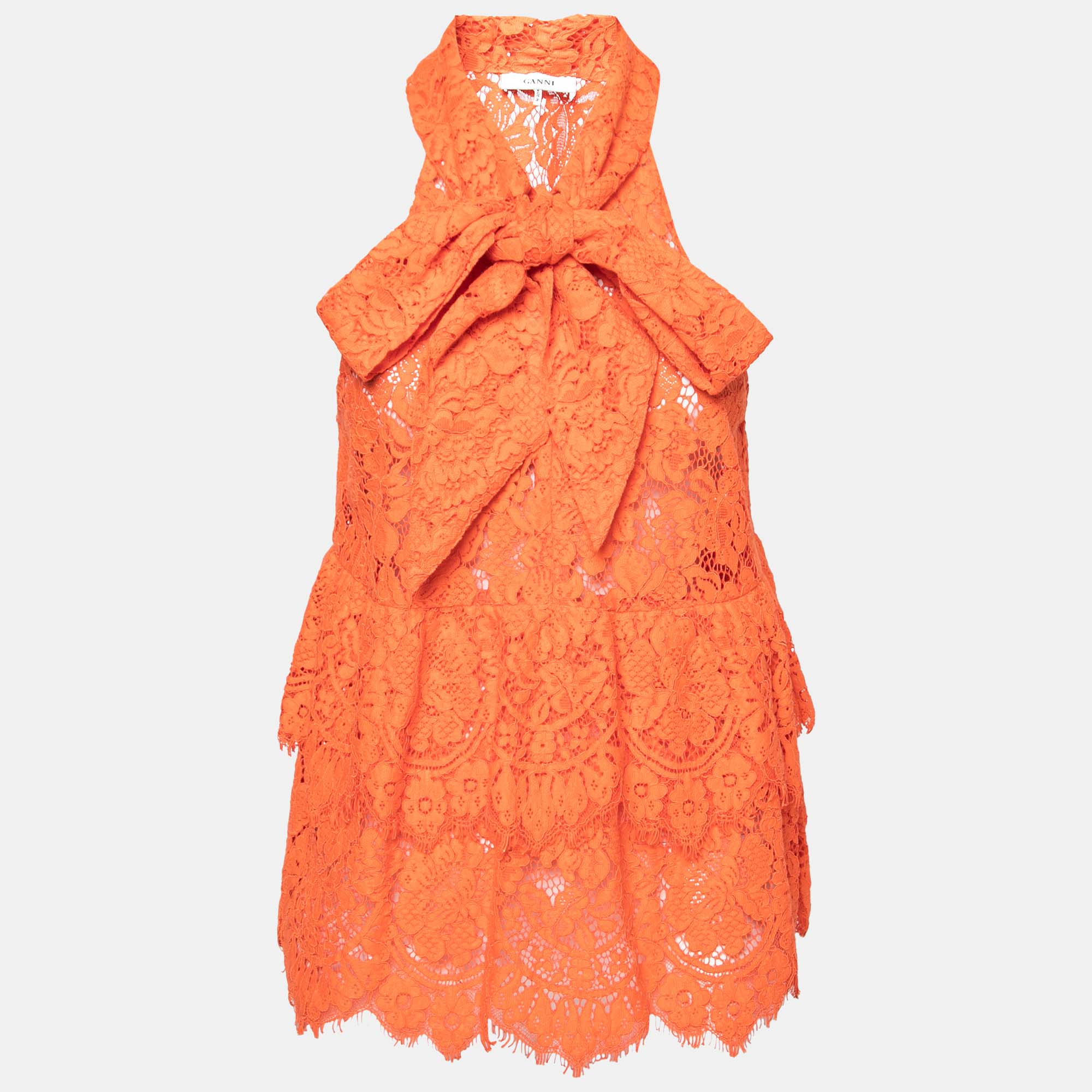 Beautiful floral lace envelopes this Ganni top to grant a chic feminine touch to your outfit. Featuring a lovely orange hue tiered formations and a sleeveless style this top is finished with lacy edgings and a cute necktie. Style it with contrasting accessories and tall heels to make an impressionable statement.