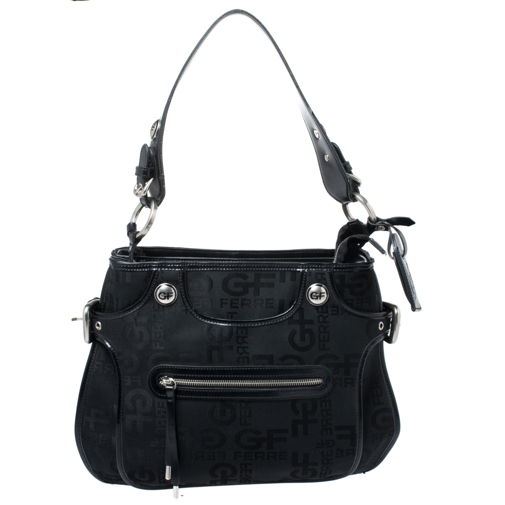 Flaunt your exclusive taste for fashion with this signature printed fabric and leather handbag. Spacious interior lined with fine nylon promises durability without any compromise. Made by GF Ferre it is an immaculate balance of sophistication and rational utility. This black bag with a front zip pocket will look fabulous everytime you carry it.