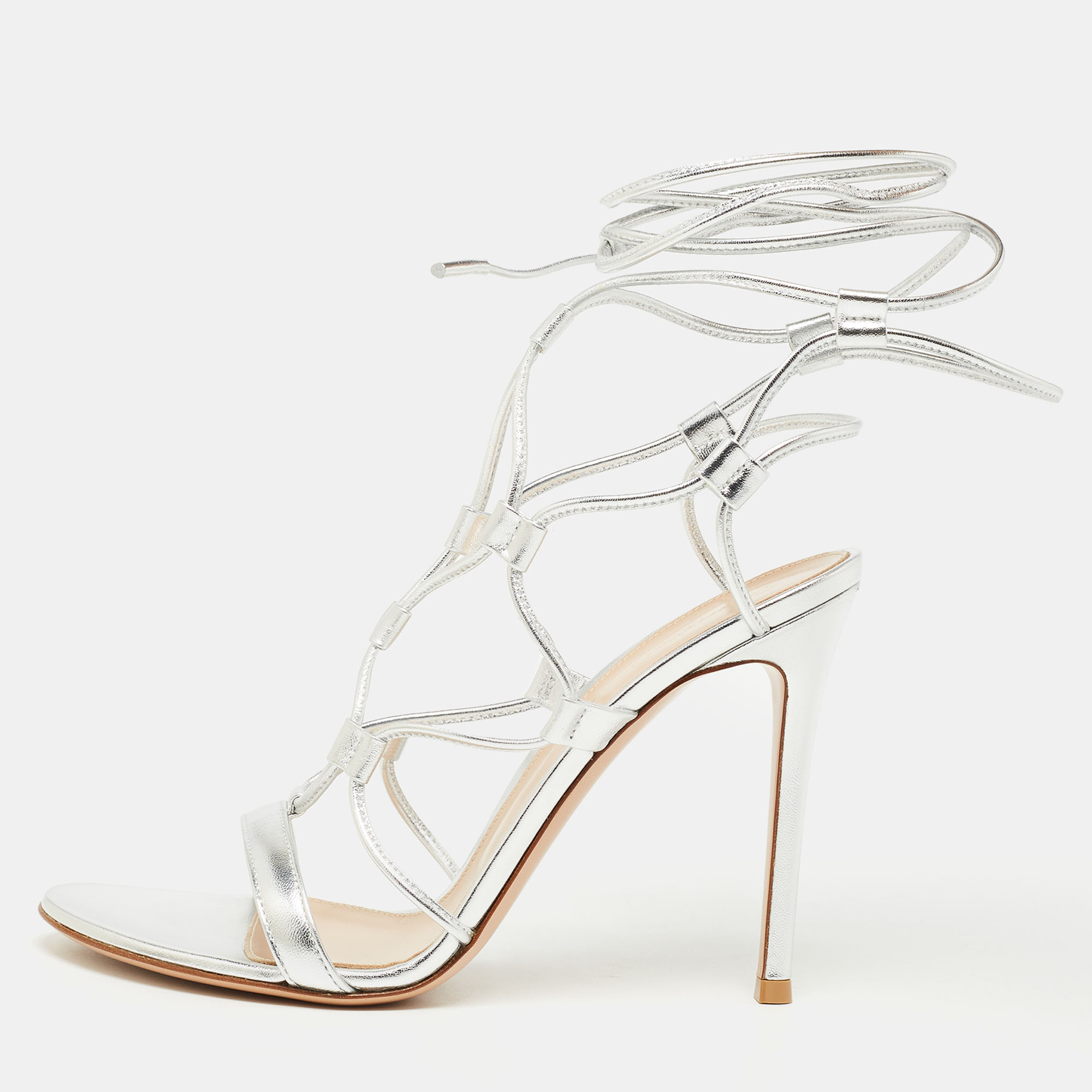 In classy silver leather the Gianvito Rossi Giza sandals exude confident charm. Delicate straps gracefully embrace the foot while a sturdy heel provides stability and style. With impeccable craftsmanship and timeless design these sandals effortlessly command attention adding a bold statement to any ensemble