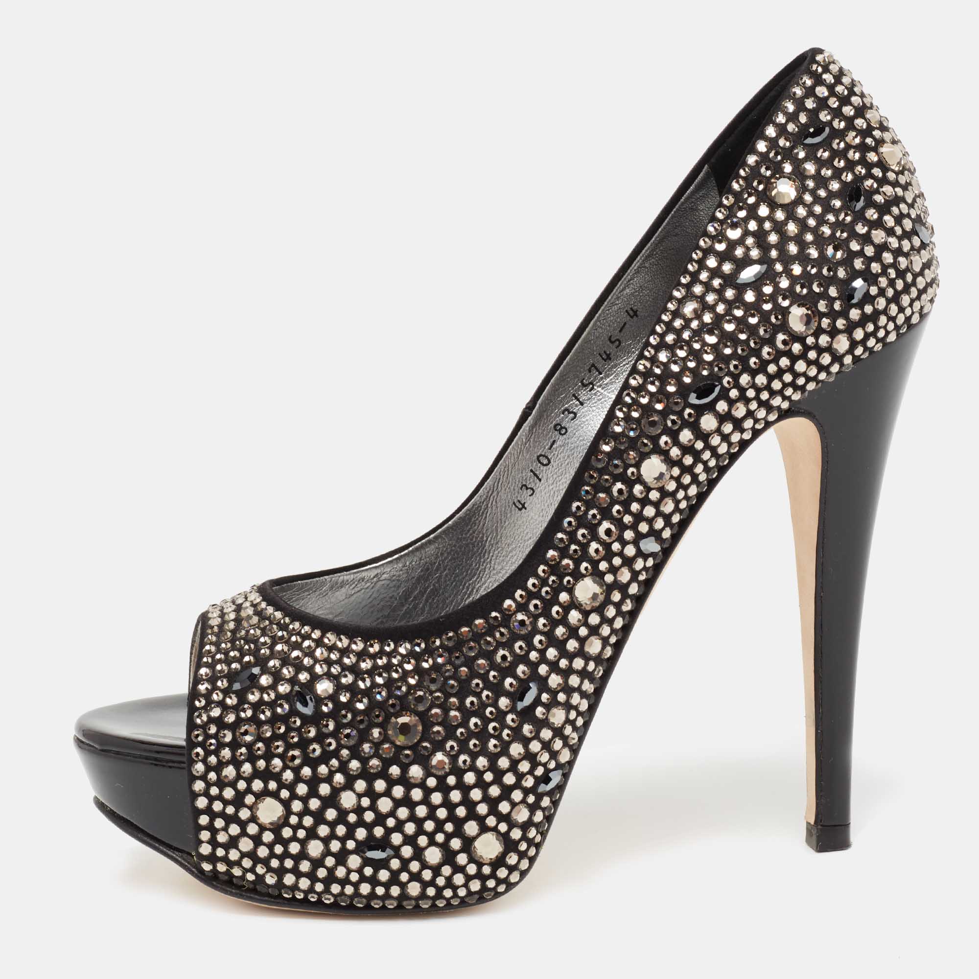 Take every step with elegance and style in these pumps from the House of Gina. They are crafted meticulously using black satin which is highlighted with crystal embellishments. They showcase platforms peep toes and tall heels. These pumps will be your favorite pair in no time