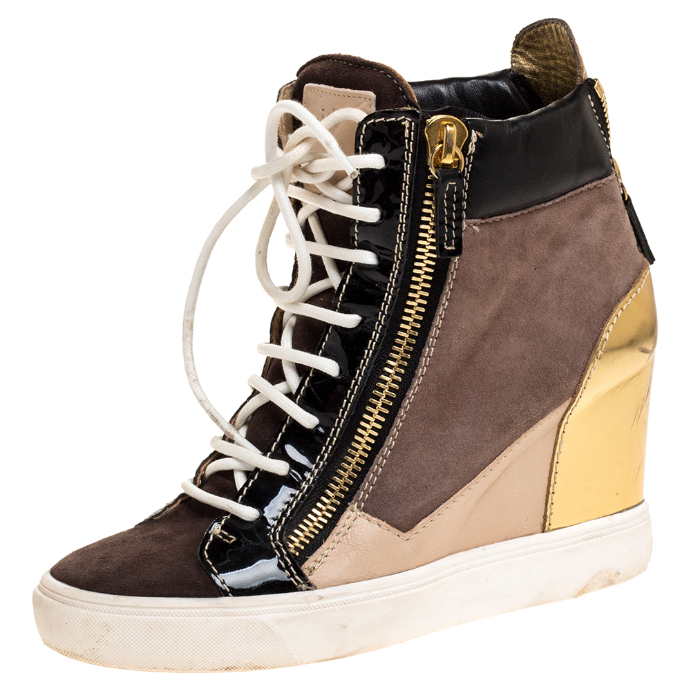 Comfort comes wrapped in these sneakers from Giuseppe Zanotti. They are crafted from suede as well as leather and they bring details of lace ups and zippers. Elevated on wedge heels these sneakers are easy to wear all day without compromising on style.