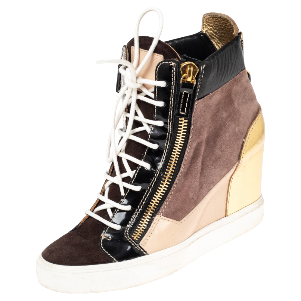 Comfort comes wrapped in these sneakers from Giuseppe Zanotti. They are crafted from suede as well as leather and they bring lace ups and zippers. Elevated on wedge heels these sneakers are easy to wear all day without compromising on style