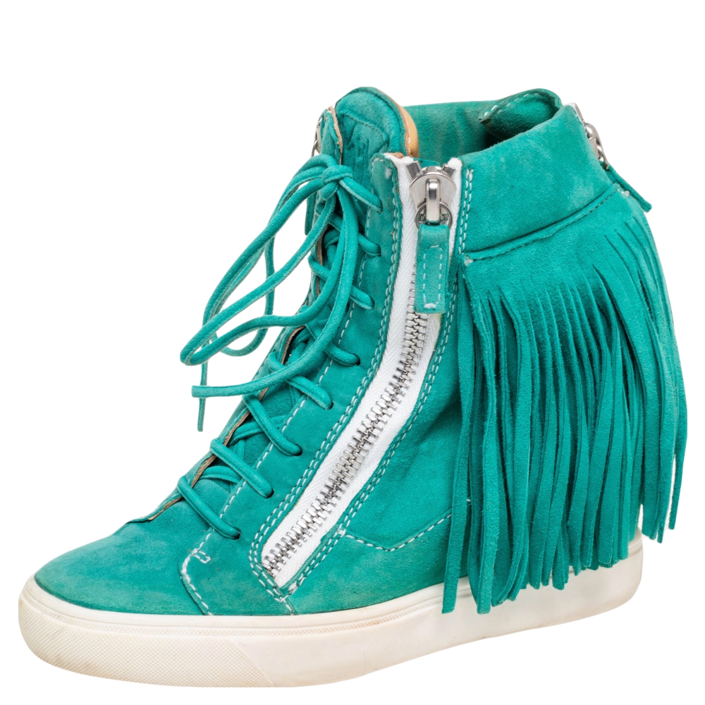 Comfort comes wrapped in these sneakers from Giuseppe Zanotti. They are crafted from suede and they bring details of lace ups fringes and zippers. Elevated on wedge heels these sneakers are easy to wear all day without compromising on style.