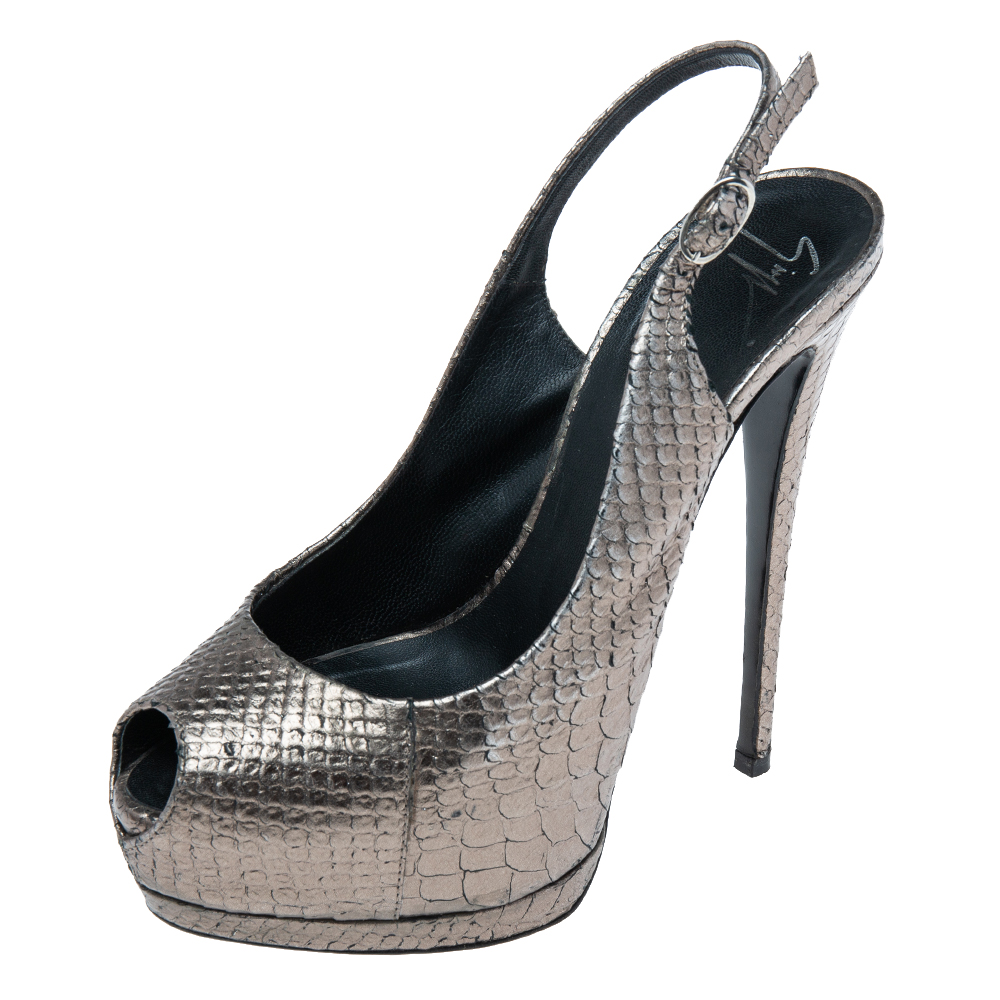The House of Giuseppe Zanotti brings you these impressive sandals that will complement any outfit perfectly. They are made from metallic python embossed leather into an eye catching silhouette. They come with peep toes platforms silver toned fittings and a slingback. Tall 14 cm heels complete them.