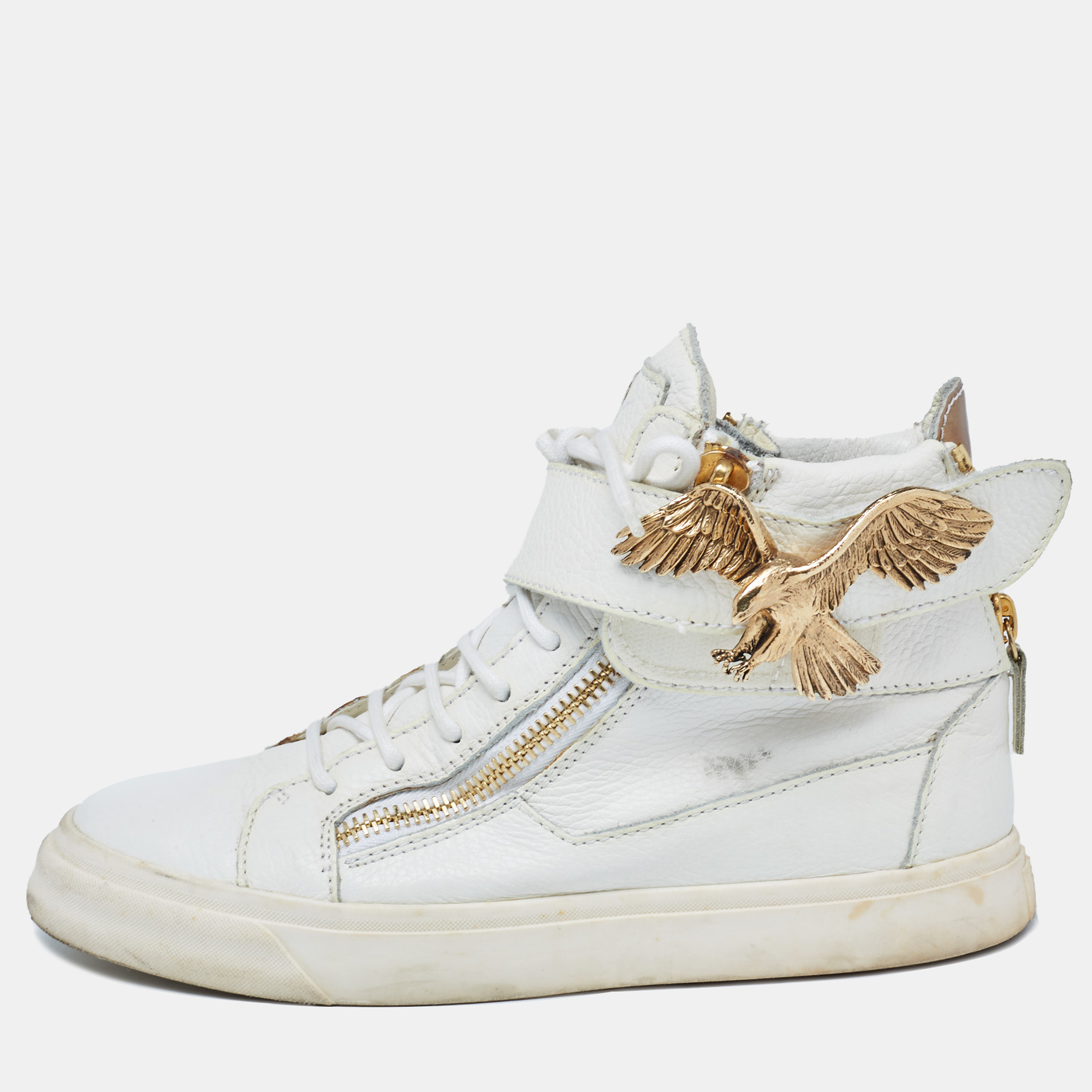 The rubber sole of these Giuseppe Zanotti sneakers will ensure optimal grip while walking. Constructed from leather the design is made eye catching with gold tone embellishments and they feature lace up vamps. The zipper details on the front and on the counter make these shoes an easy to wear pair.