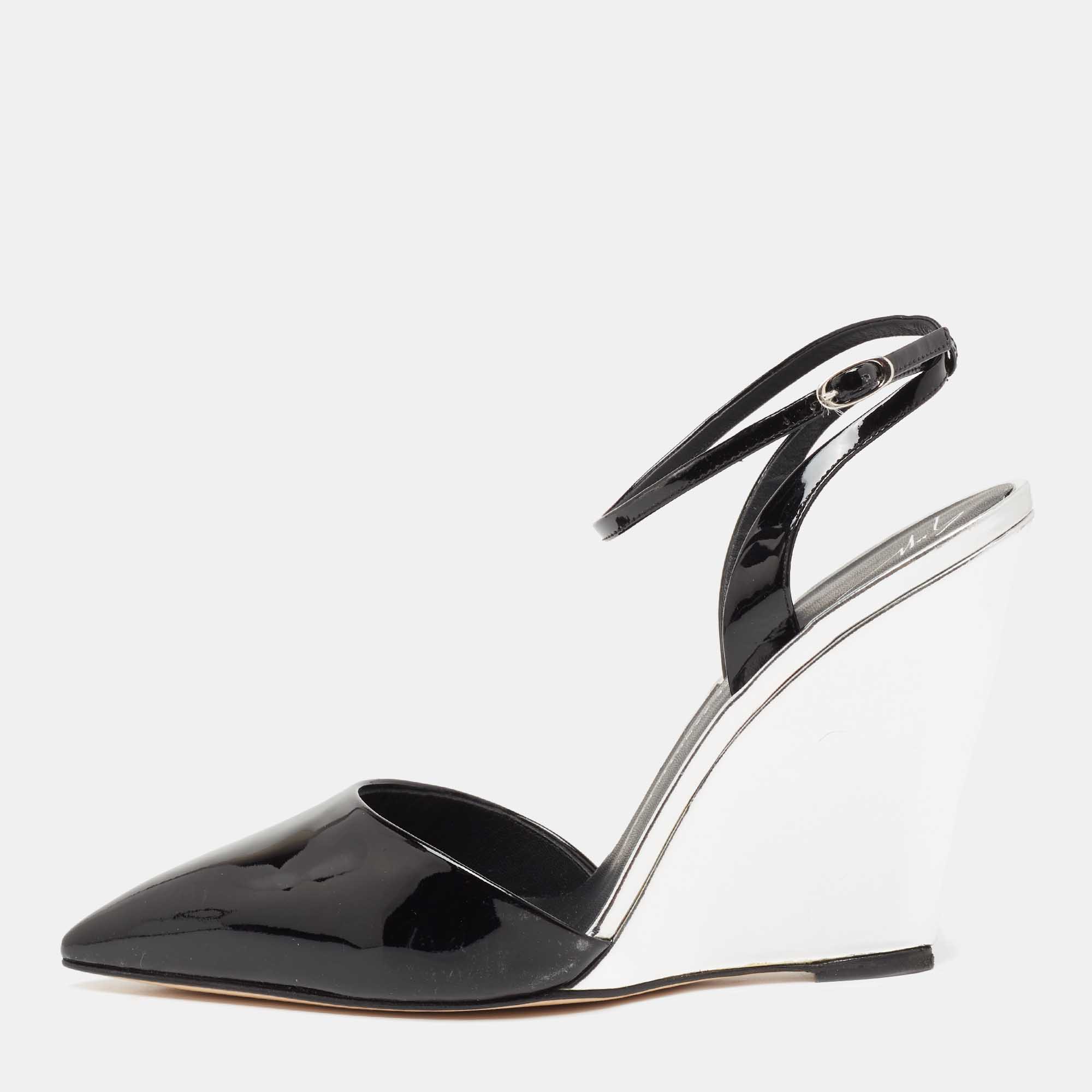Giuseppe Zanotti yet again takes a simple silhouette and adds a chic touch to it These pumps have been crafted from patent leather in black and silver and are elevated by sleek pointed toes and 11 cm wedge heels.
