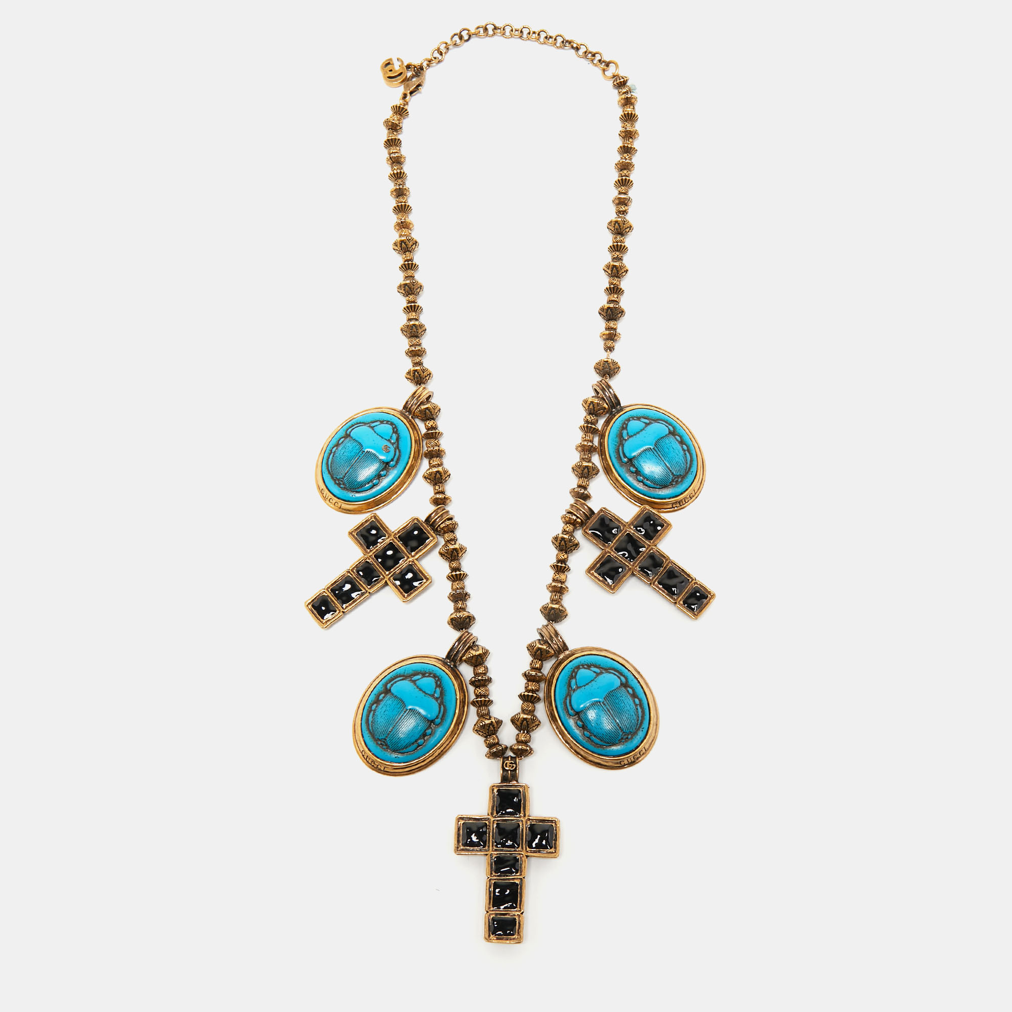 

Gucci Aged Gold Tone Scarab and Cross Charms Necklace
