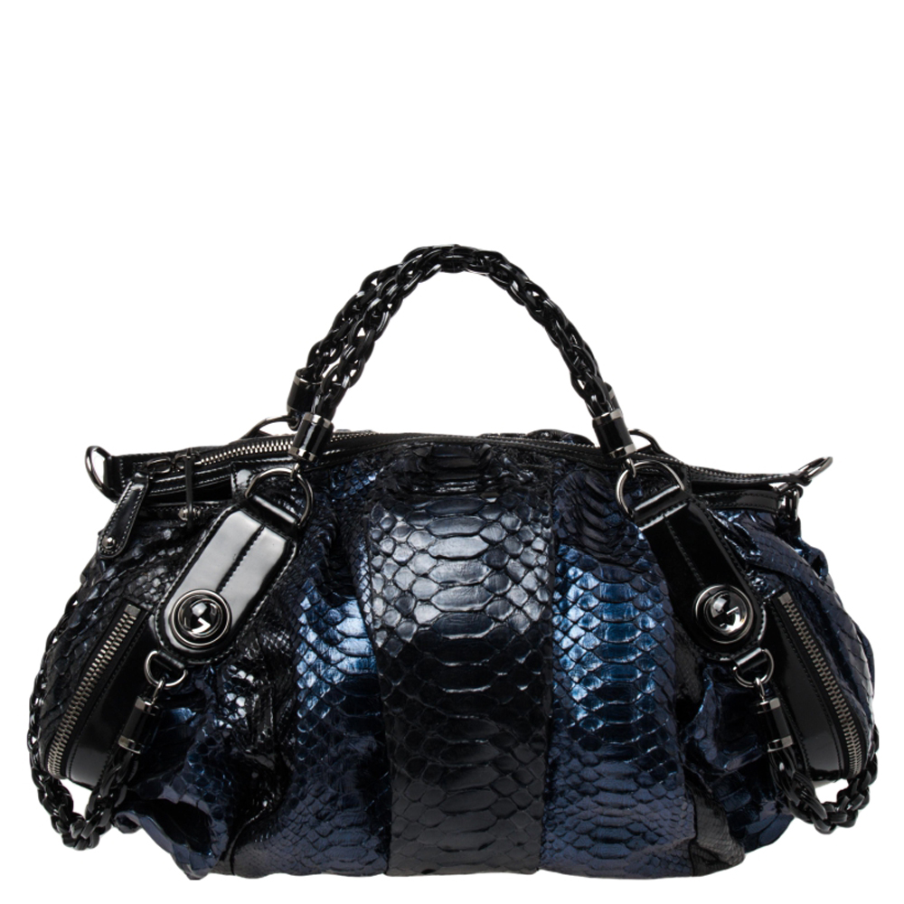 Made a fine addition to your closet with this Gucci creation. It has been crafted from python leather and patent leather. It has a shoulder strap and two top handles for you to parade it easily. The stunning hues on the exterior and the spacious interior add to the bags charm.