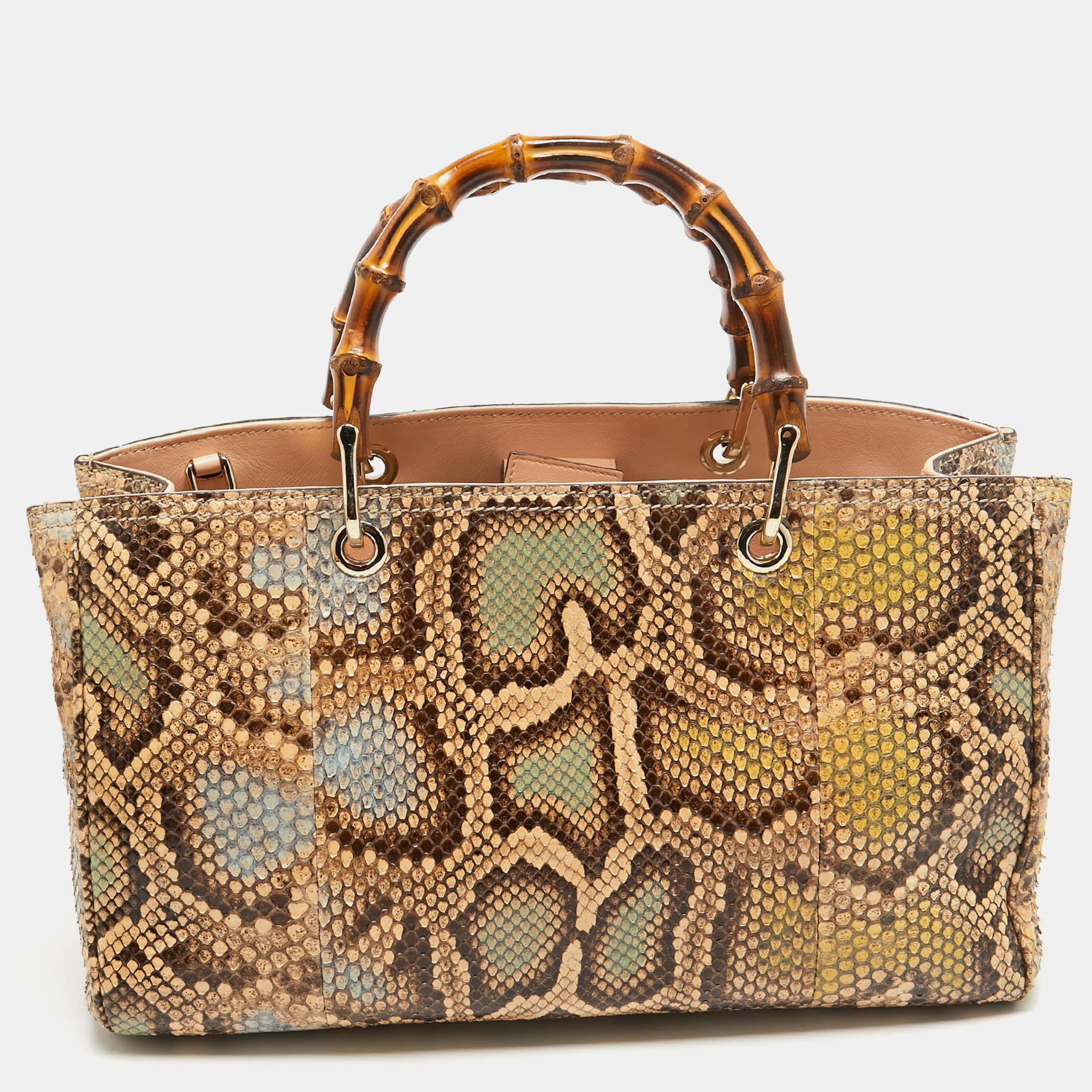 This Gucci Bamboo tote promises to take you through the day with ease whether youre at work or out and about in the city. From its design to its structure the python leather bag promises charm and durability. It has top bamboo handles and a spacious interior to hold all your essentials.