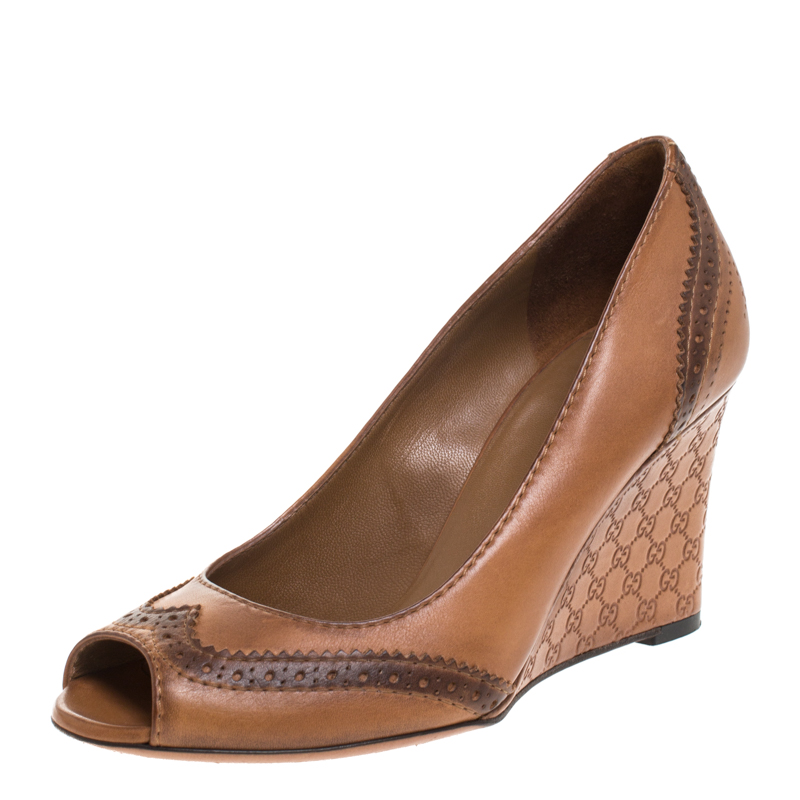 Click to view more detailed imagery on our partner's website Gucci Brown Brogue Leather Wedge Peep Toe Pump Size 35