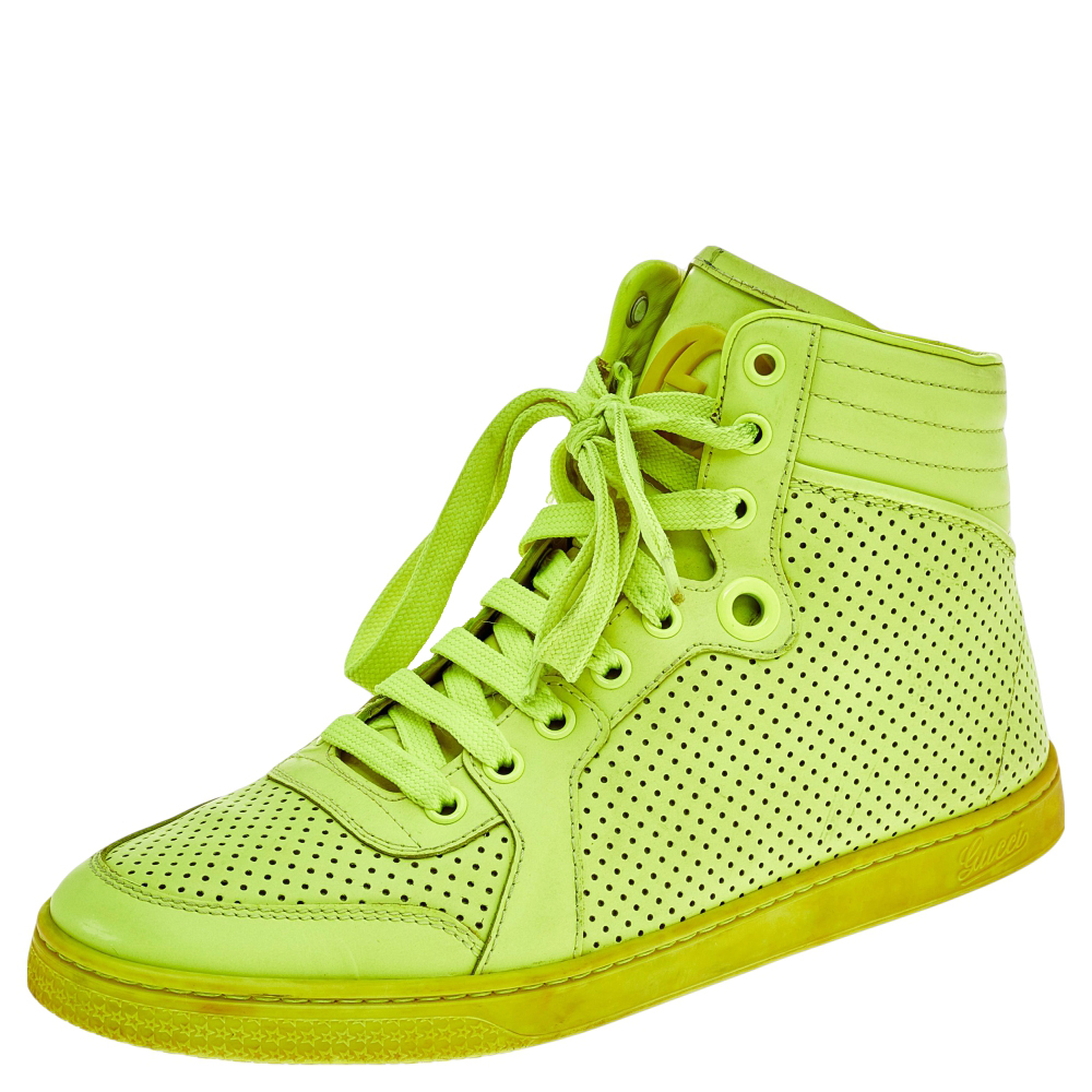 An eye catchy and trendy pair as this one is sure to fetch you praise and attention. This pair of sneakers from the House of Gucci is created using neon green perforated leather and flaunts a lace up feature high top profile and matching hardware. Look exemplary in this pair of Gucci sneakers.
