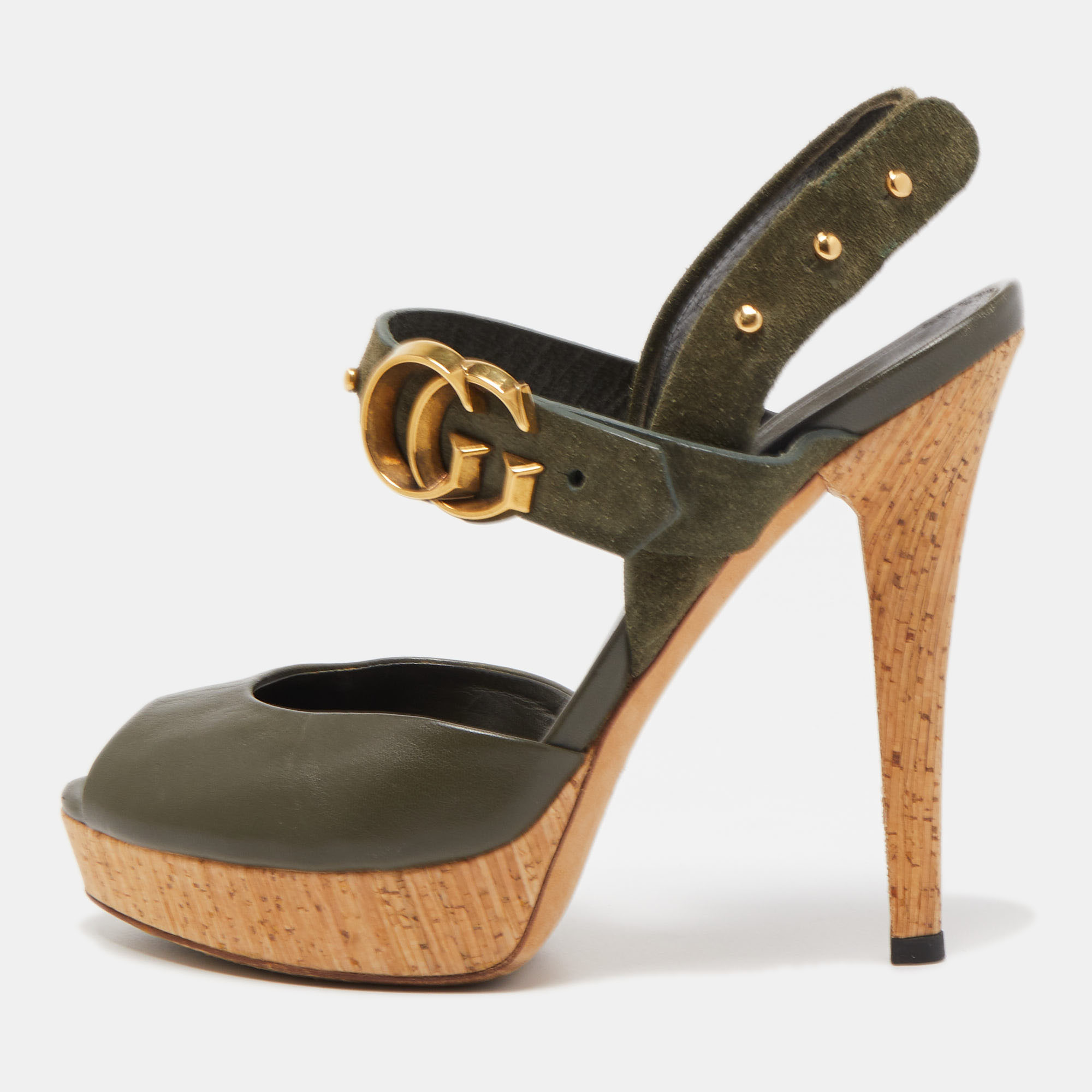 Enter the room stylishly in these olive green Gucci sandals. They have been made from leather and suede and flaunt complementing gold tone hardware. They have an ankle strap design and are supported on lovely cork platforms and 11cm heels.