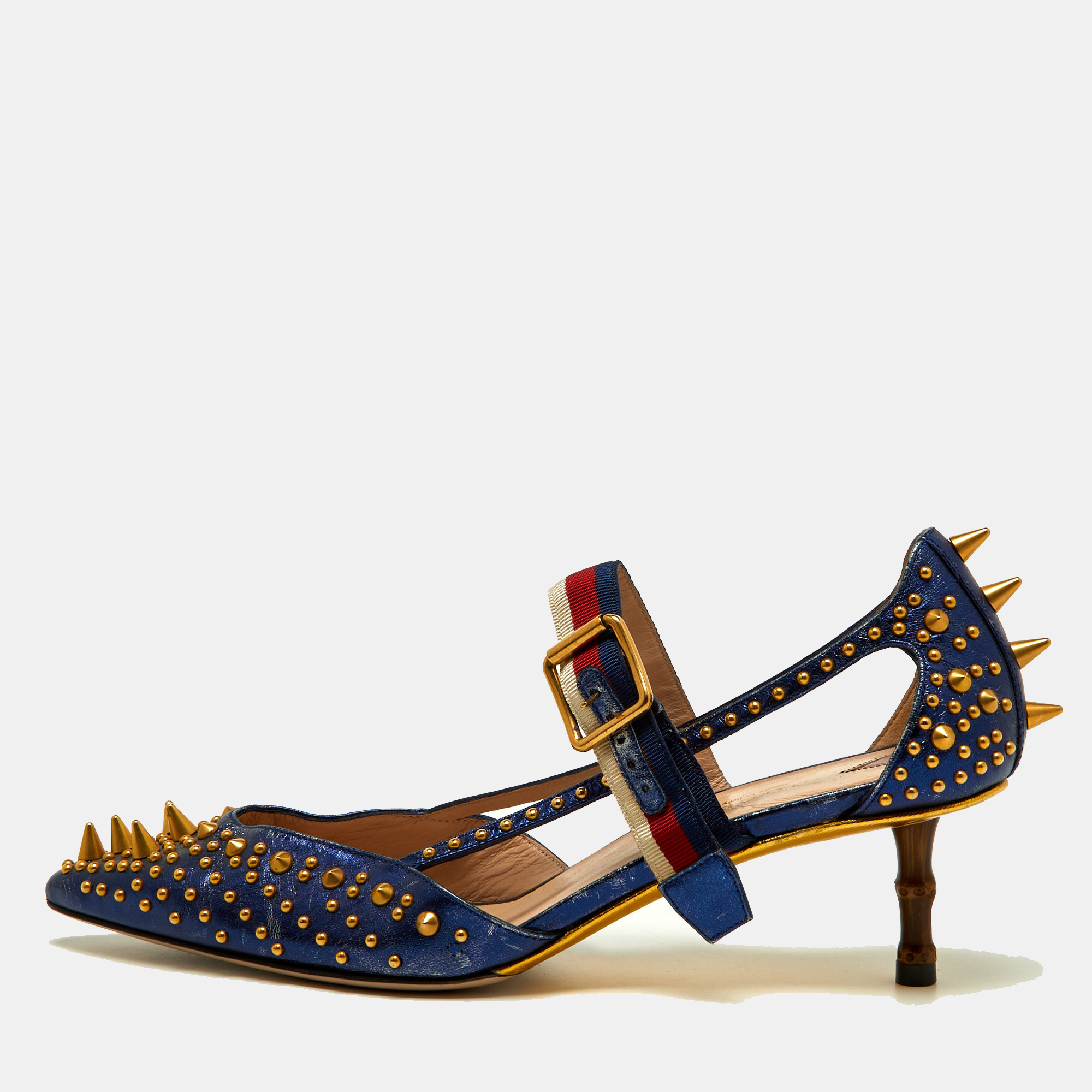 These pointed toe Unia pumps from Gucci have come straight from a shoe lovers dream. Crafted from blue leather detailed with gold tone studs all over along with signature Web straps on the ankle and are balanced on 5.5cm heels. The pumps are lovely and gorgeous