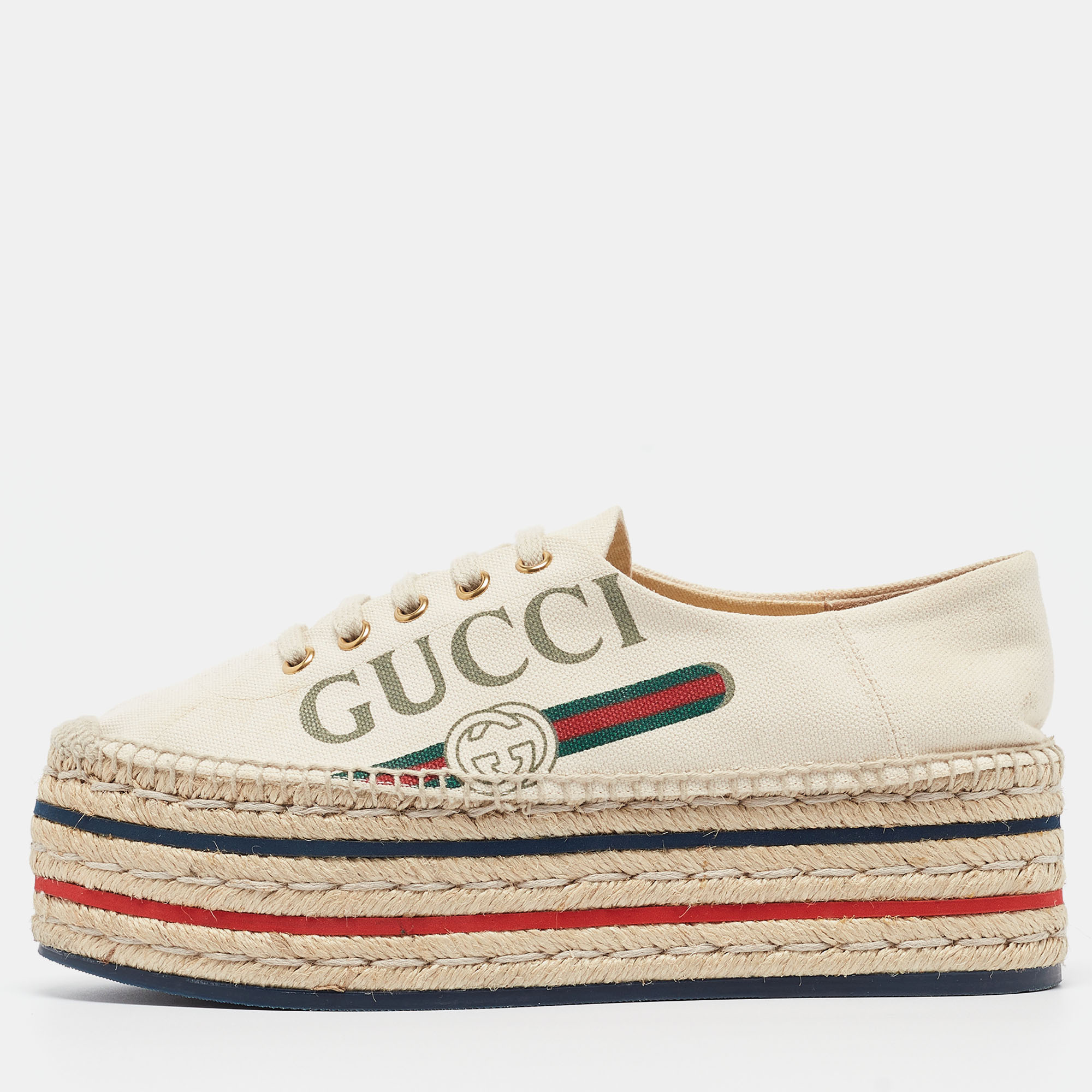 Step out in style with these chic espadrilles from Gucci These cream platform shoes are crafted from canvas and feature round toes brand detailing lace ups and espadrille platforms that offer an elevated walk. This is one pair you definitely need to get your hands on