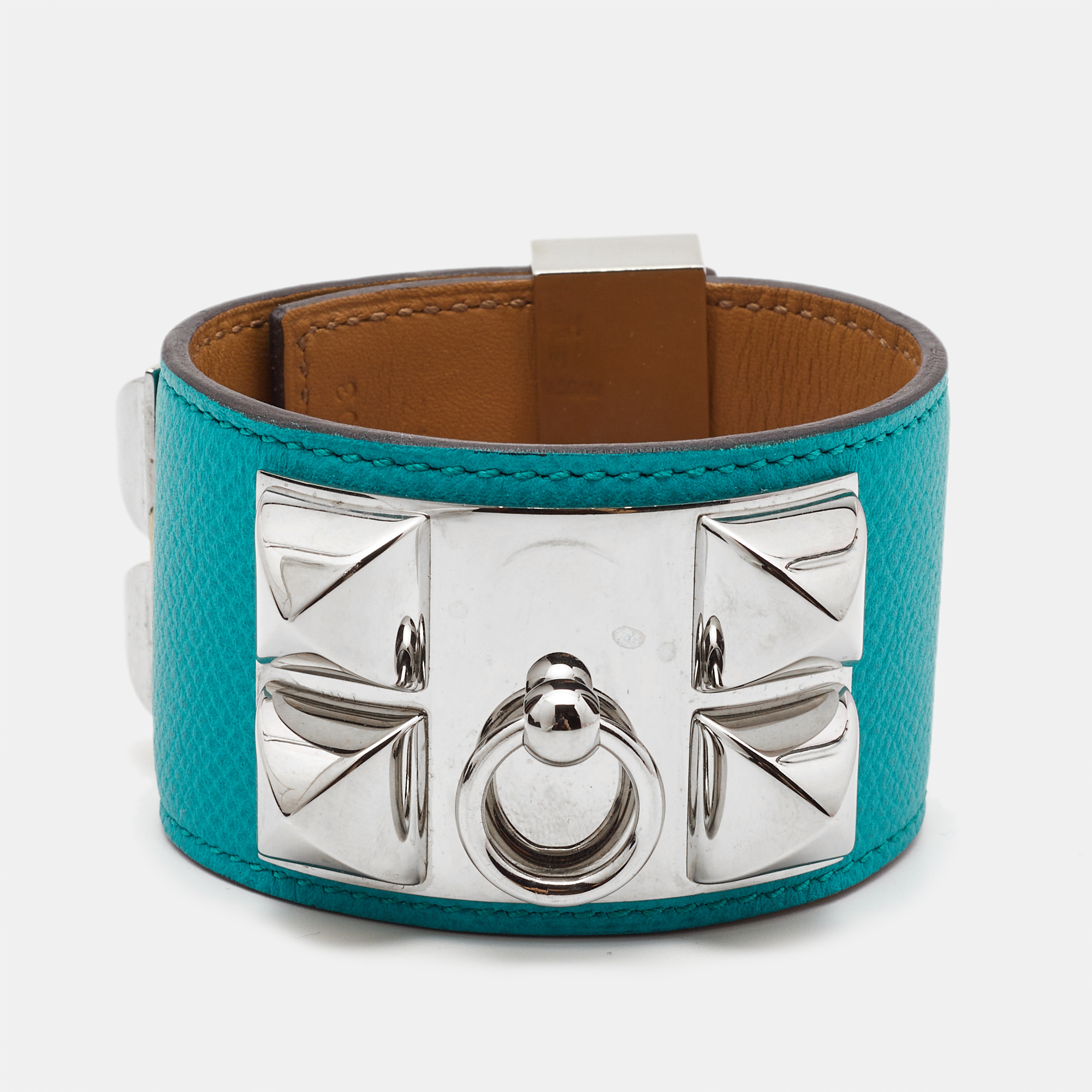 This instantly recognizable bracelet is from the signature Collier de Chien collection by Hermès. The bracelet made of leather is adorned with the iconic Collier de Chien motif in palladium plated metal involving pyramid studs and a ring. It is completed with a classy lock. This bold creation is an interpretation of the dog collar made by the label in 1923 which paved the way for various design iterations.