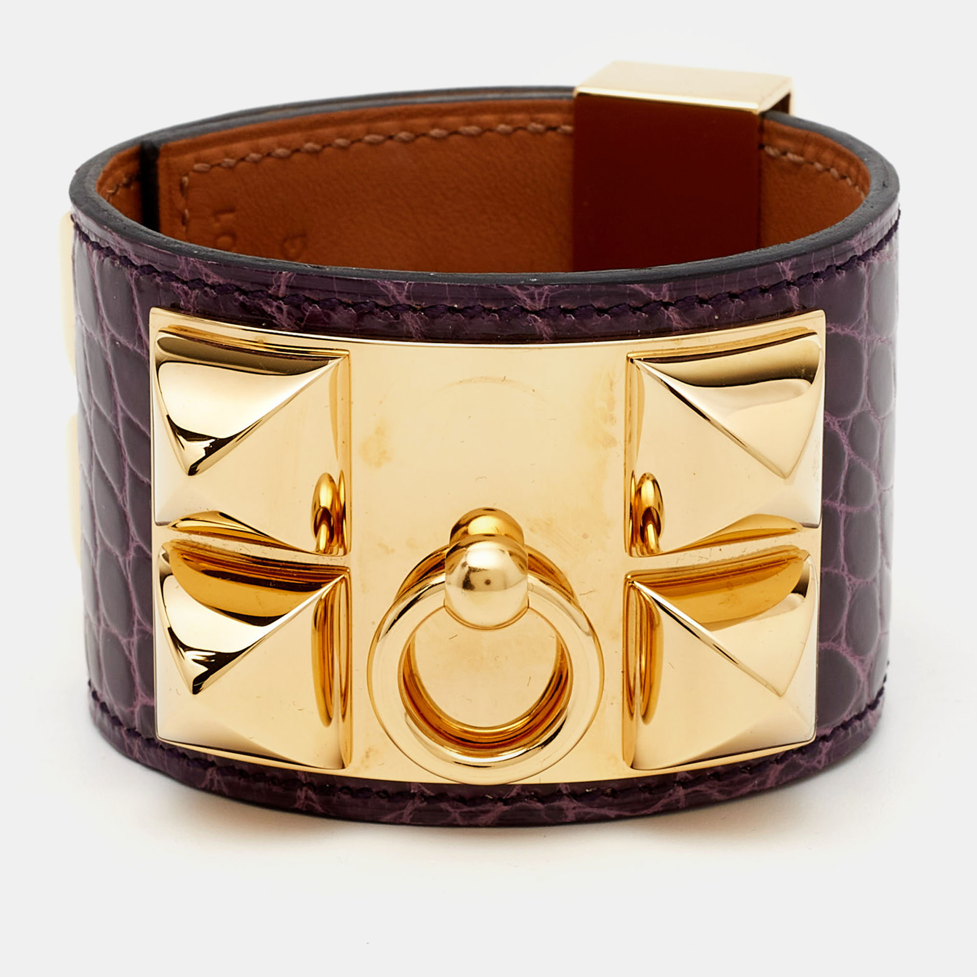 Add Hermes magic to the way you accessorize with this bracelet. This alligator leather bracelet is styled with fine lines and gold plated metal. Highlighted by signature details it is sure to add luxury charm to your ensemble.