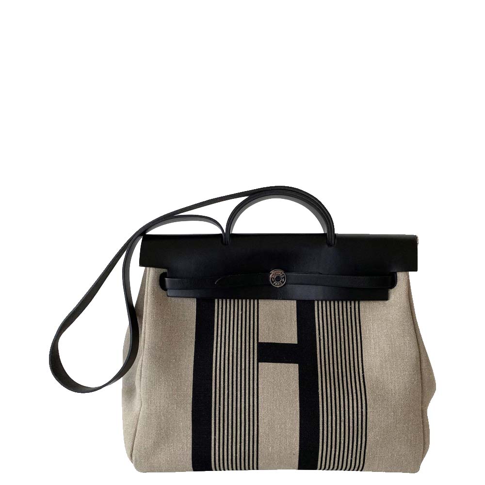 This bag from the house of Hermes can work well for any occasion. Be the epitome of grace as you step out with finesse in this beige and black bag. Shaped in canvas this bag is a dressy piece to include in your collection this season.