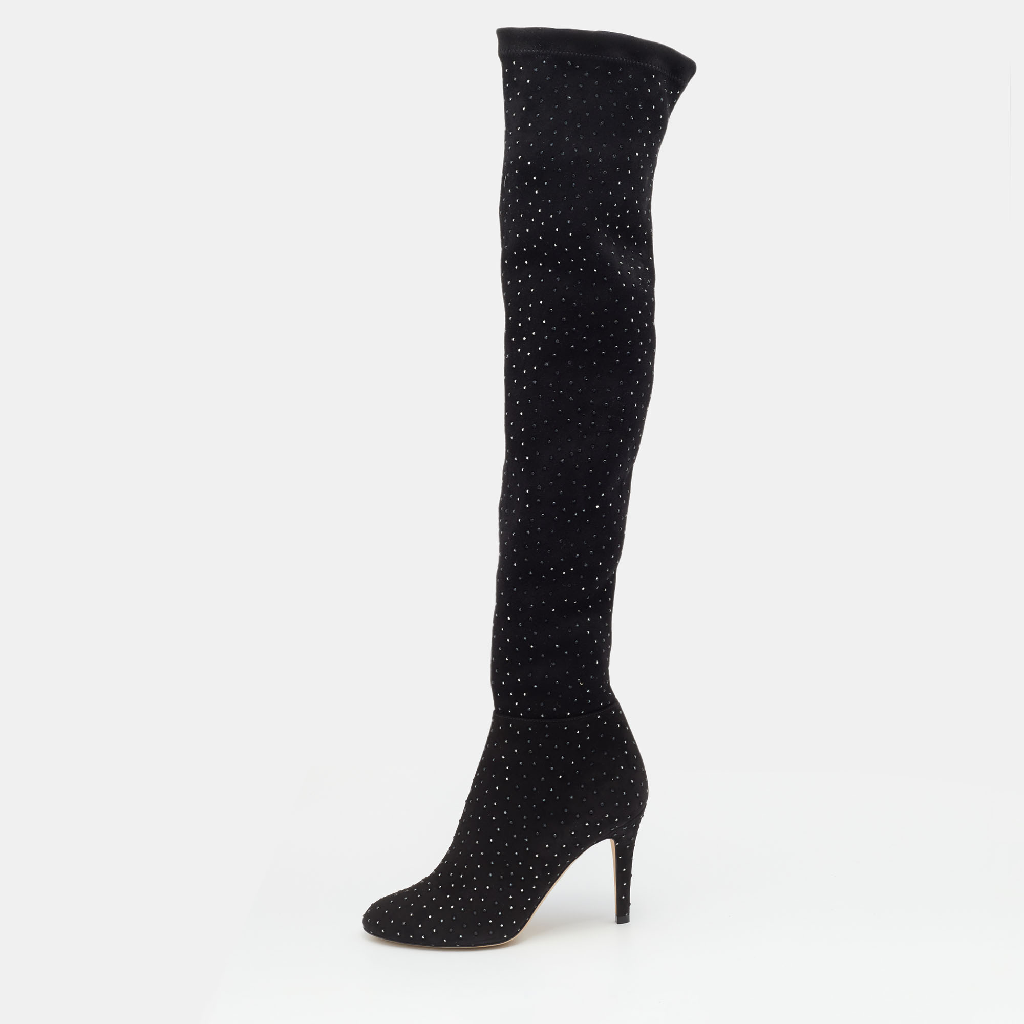 Jimmy Choo brings you this fabulous pair of thigh high boots that will give you confidence and loads of style. The shoes have been crafted from stretch fabric in a classy black shade and styled with embellishments and 9 cm heels.
