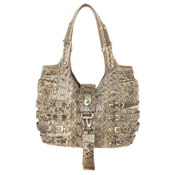 This stylish tote by Jimmy Choo is a rare accessory to own. It is crafted from crinkled snakeskin leather and features decorative studded buckle straps with large leather tab key chain fold over tab with turnlock closure double shoulder straps and dual slit pockets at top corner sides. The alcantara lined interior houses one zip and one open pocket. Original Retail Price: US $1 695