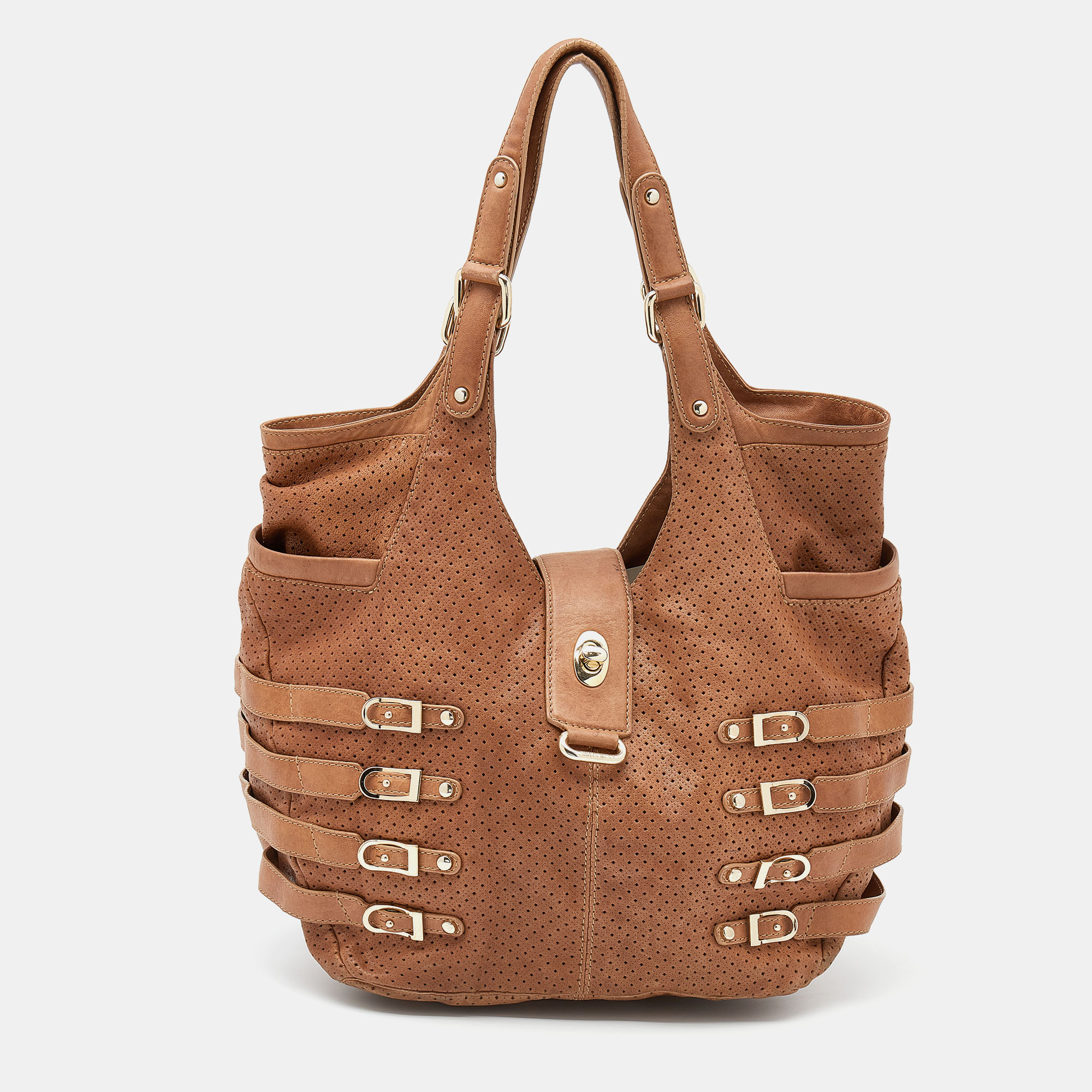 Elegance meets luxury in this Bardia bag from the House of Jimmy Choo. It is created using brown perforated leather. It has an Alcantara lined interior silver tone hardware and a 28 cm handle drop. This bag will elevate your look immediately
