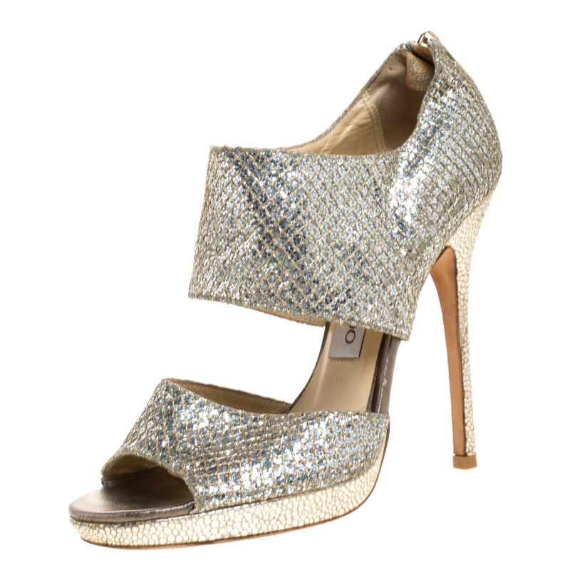 This stylish chic and modish pair of Private platform sandals for parties by Jimmy Choo is all youll need. It is crafted from beautiful glitter fabric and comes with two broad straps. The insoles are leather lined and carry brand labeling along with zipped counters. It is elevated on 12cm tall heels.