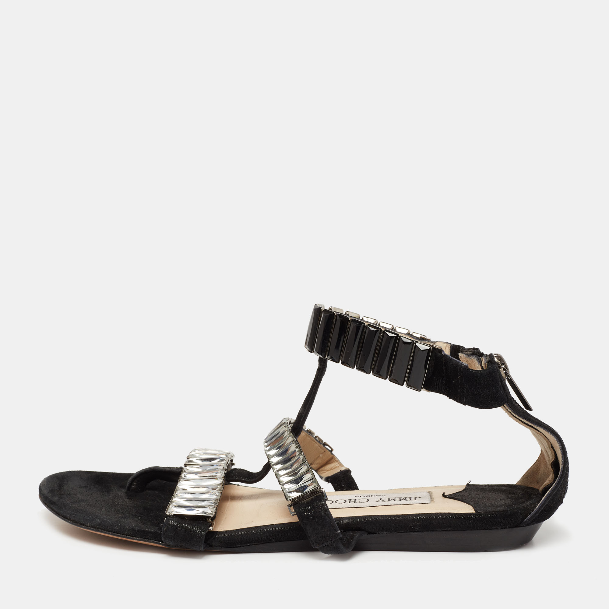 Perfectly blending comfort and style these glamorous flat sandals from Jimmy Choo need to be owned by you They are crafted from black suede and flaunt mesmerizing crystal embellished straps. They are equipped with back zippers along with comfortable leather insoles and soles.