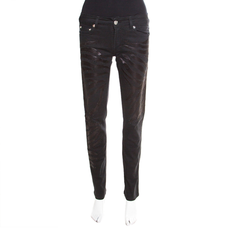 This Just Cavalli creation represents a very unique design that just needs to be in your closet. This black washed denim pair provides a skinny fit and features stunning hot fix crystals embellishments. Styled in silver tone hardware this casual piece comes with three external pockets and a zip closure.