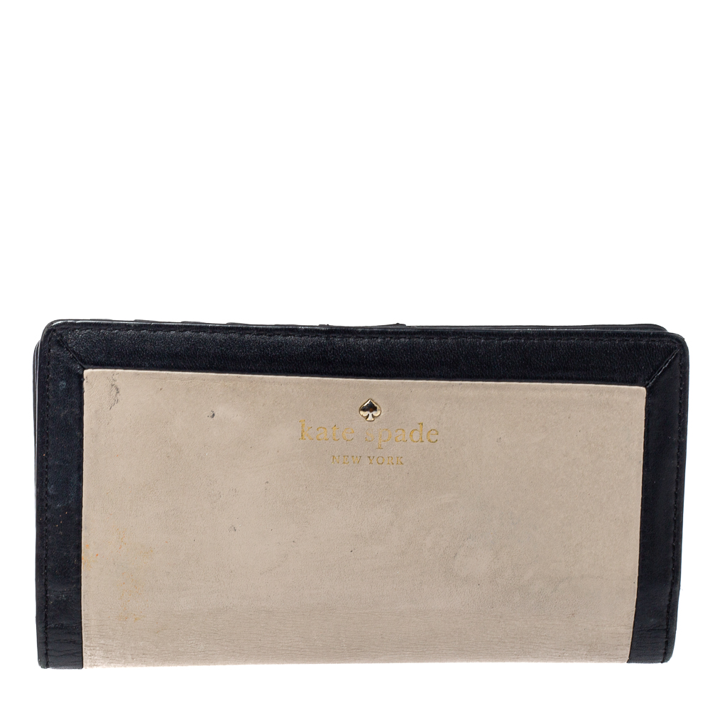 This wallet from Kate Spade has a sleek luxe look and ideal for daily use. The wallet is as functional as it is beautiful. On unsnapping it reveals a leather and fabric interior that is filled with plenty of slots slips pockets and zipper pockets for your current and growing card and receipt.