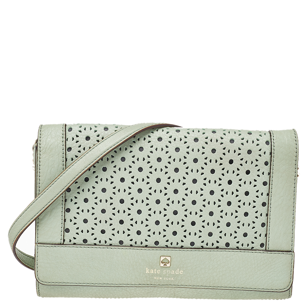 This Kate Spade bag features a mint green leather body with perforations. It features a flap silhouette and a leather shoulder strap. It opens to reveal a nylon lined interior. Carry all your evening essentials in this charming bag.