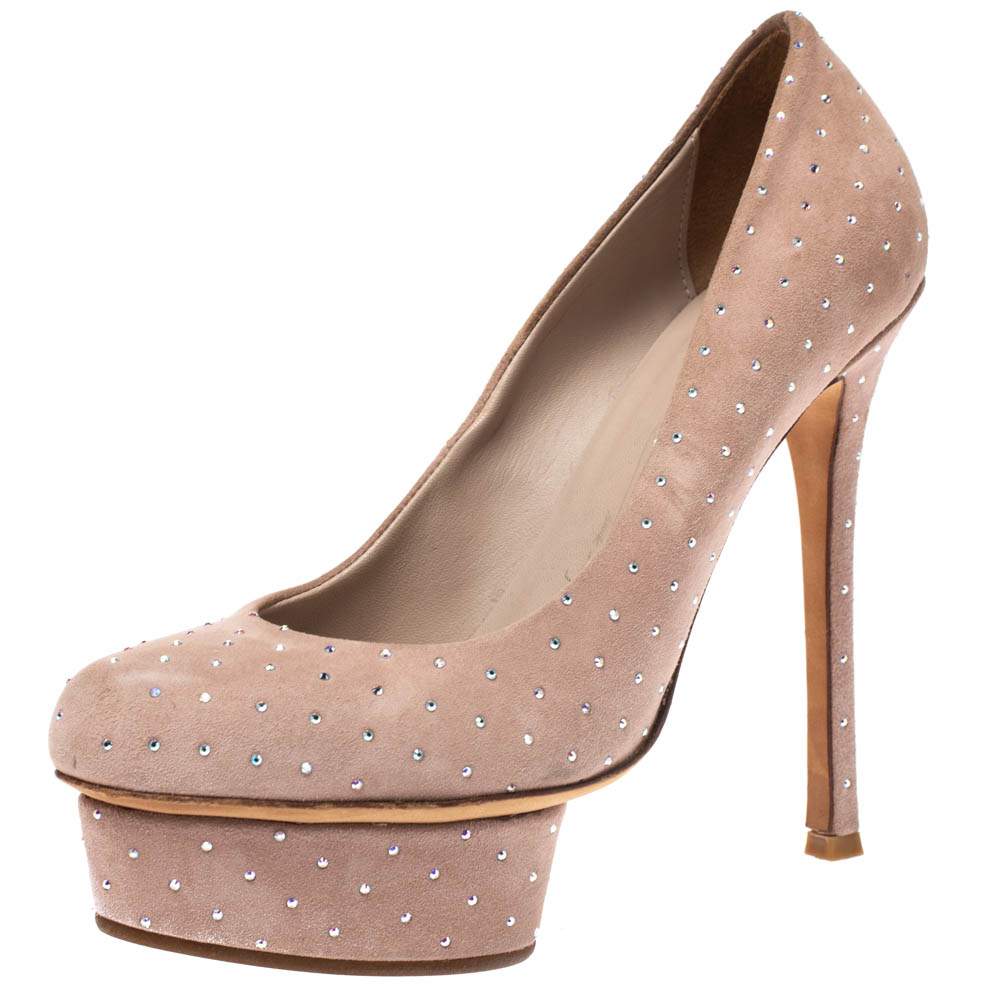 Step out in sophistication and style when you don this pair of smart Le Silla pumps. Feel beautiful and be comfortable while flaunting these suede pumps. This pair of beige pumps is styled with crystal embellishments all over stiletto heels and platforms.
