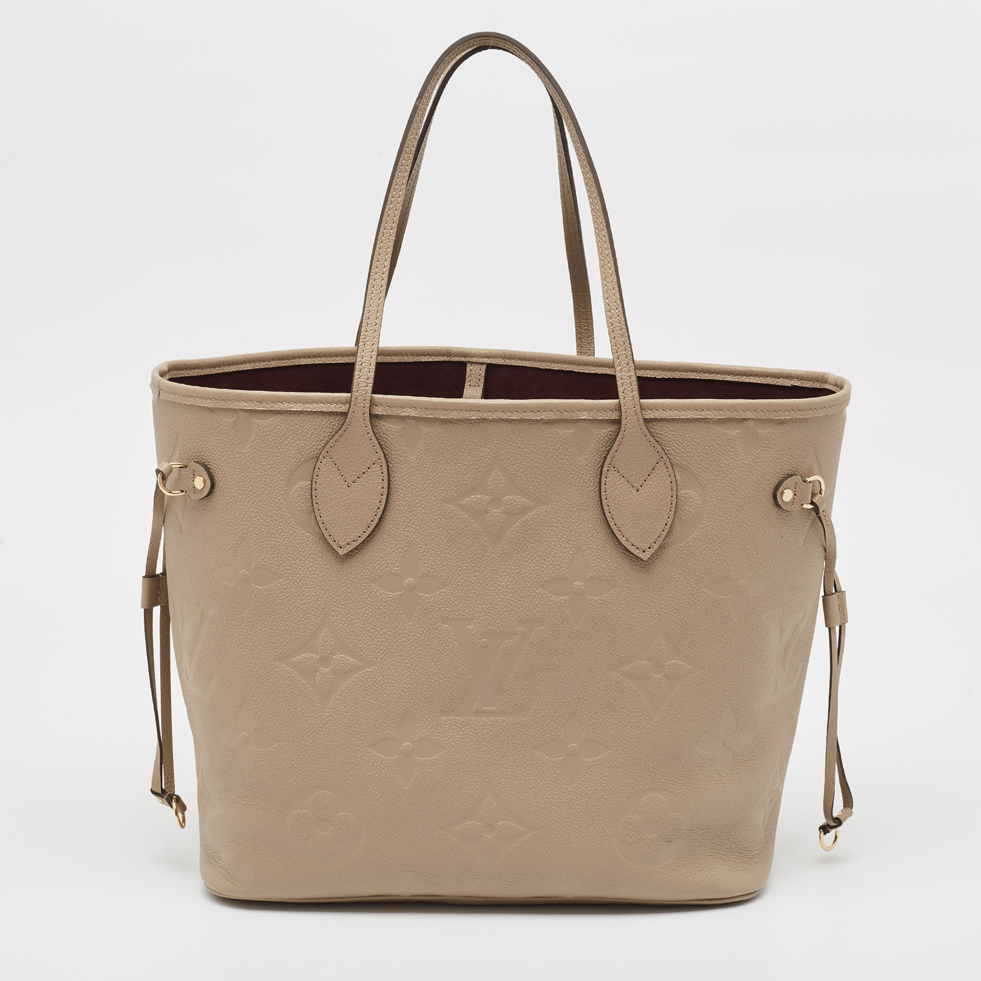 

Louis Vuitton Tourterelle Monogram Giant Empreinte Leather Neverfull MM Bag, Beige