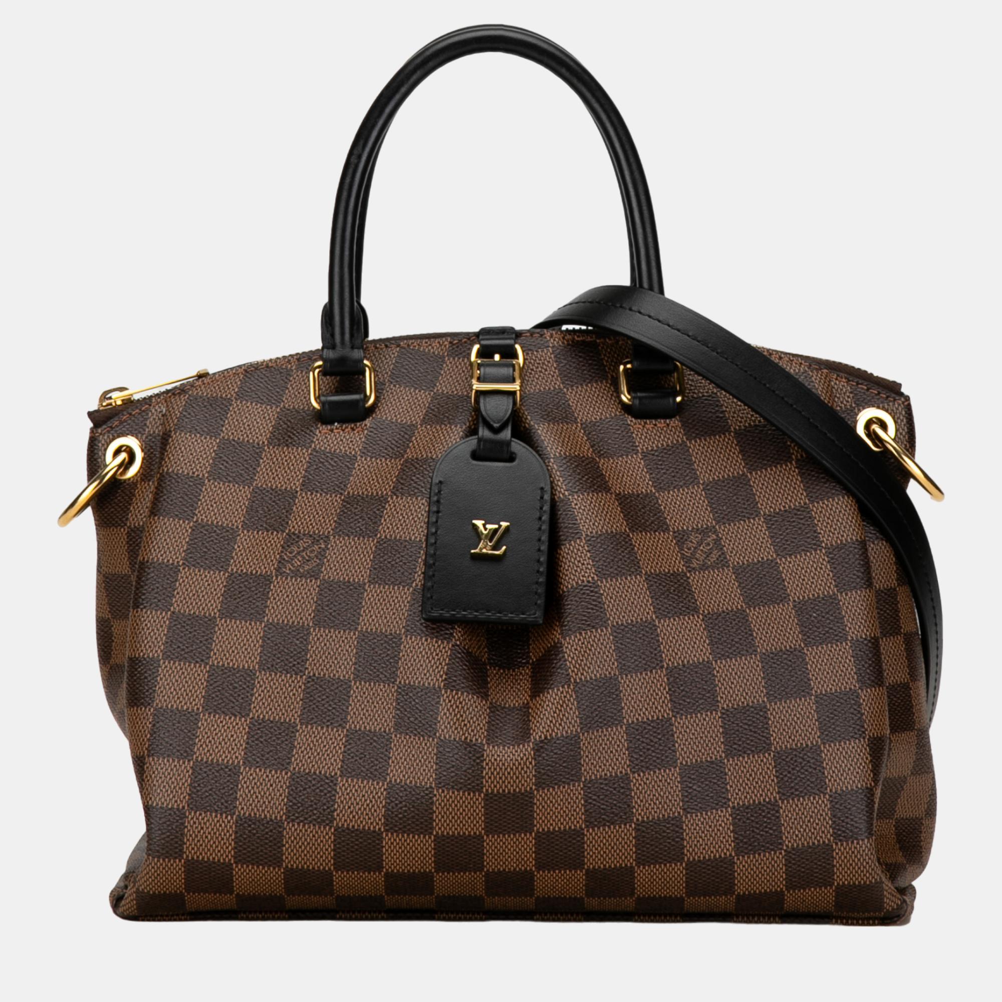 The Odeon Tote PM features a damier ebene body rolled leather handles a detachable flat leather strap a top zip closure and interior slip pockets.