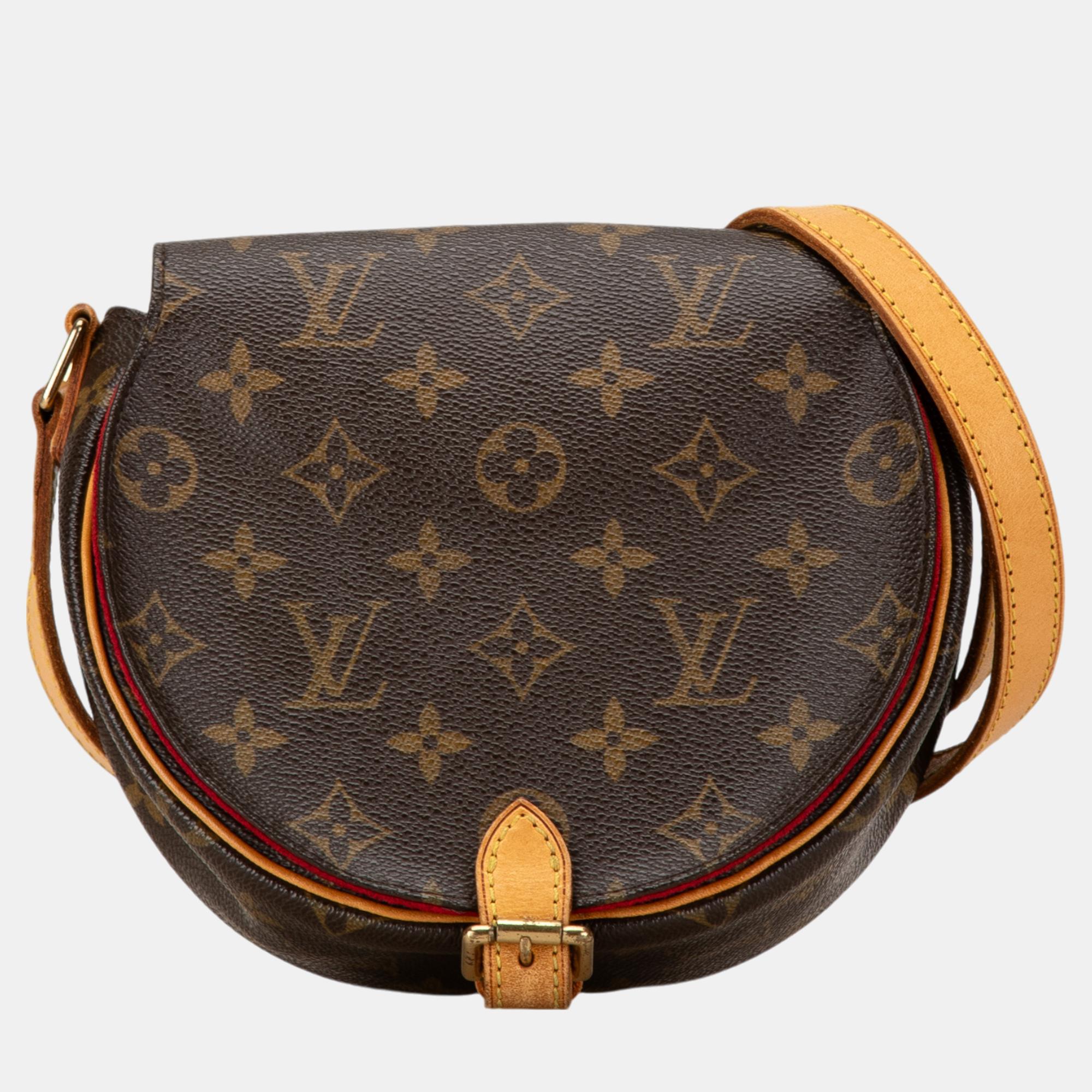 The Sac Tambourine features a monogram canvas body with vachetta leather trim an adjustable flat vachetta leather strap a front flap with magnetic snap closure and an interior slip pocket.