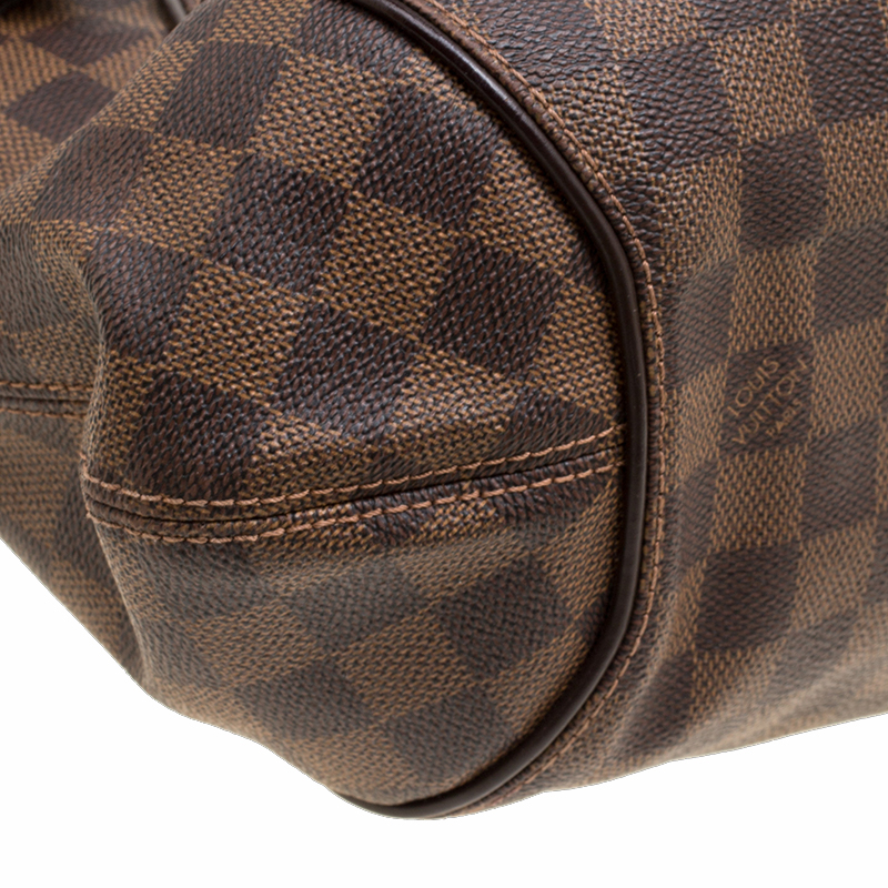 A Louis Vuitton Damier Ebene Sistina PM Bag. Brown checked canvas with  brown leather and gilded hard