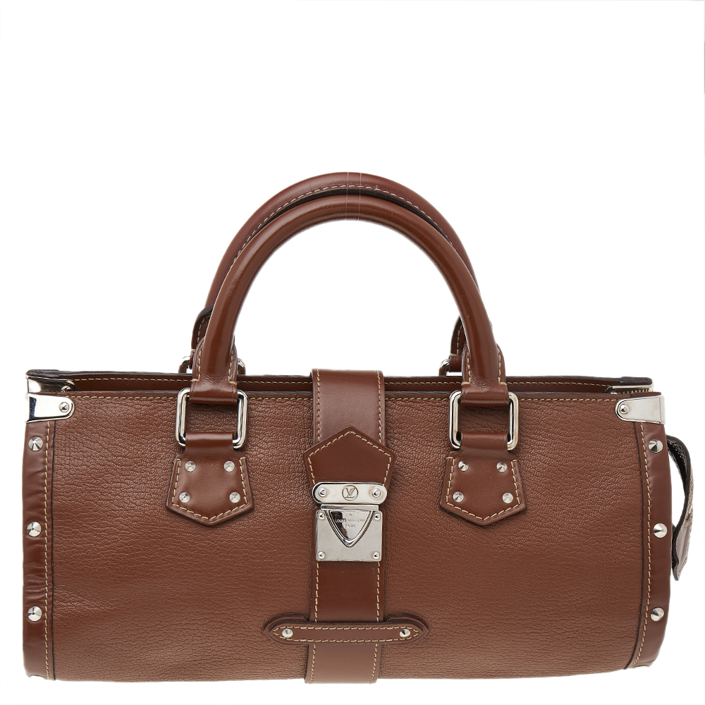 All of Louis Vuittons handbags are high on style and craftsmanship. Created from leather the LEpanoui bag has a fine finish. The bag features two top handles protective feet at the bottom and a roomy fabric interior secured by a flap with a push lock. This sophisticated bag will be a perfect addition to your closet.