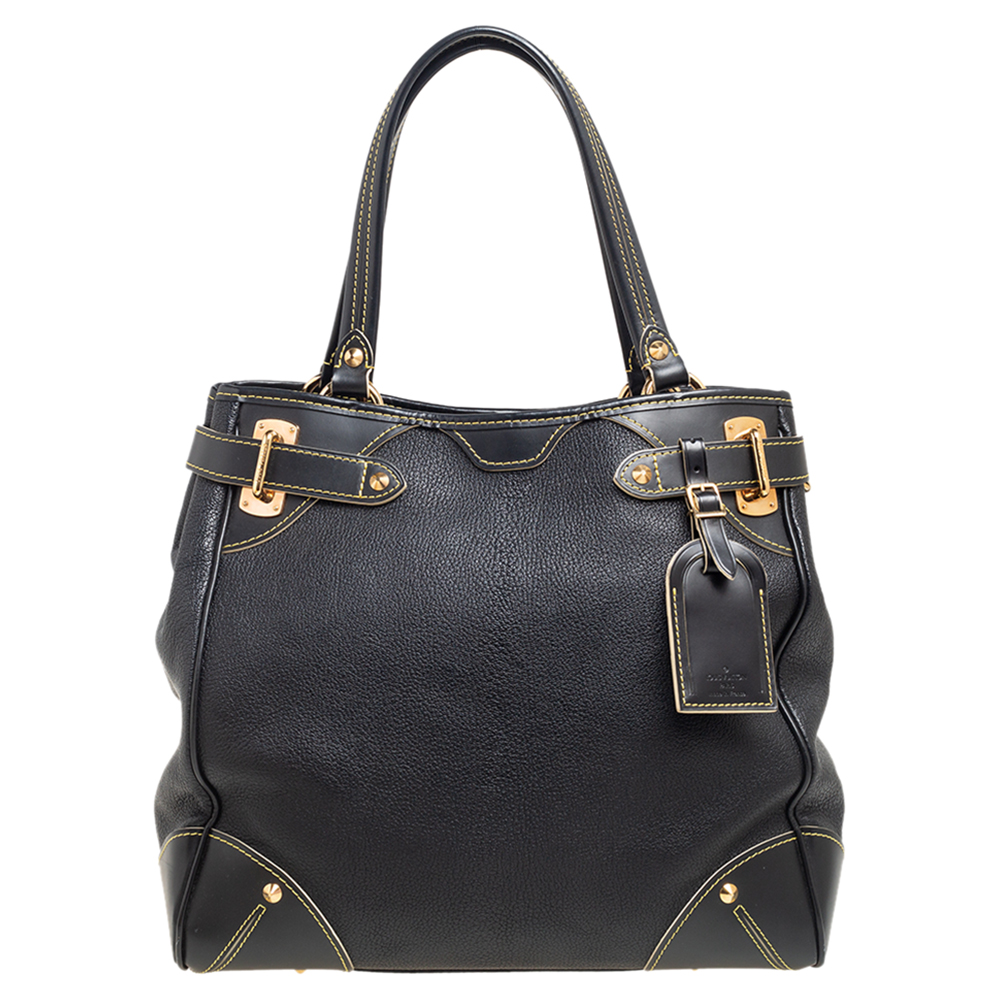 Sleek and chic this LV tote in a classic black shade is part of the Le Majestueux collection. Made from Suhali leather this bag is accented with buckle motifs an LV tag and gold tone hardware. It is complete with two handles and a spacious interior.