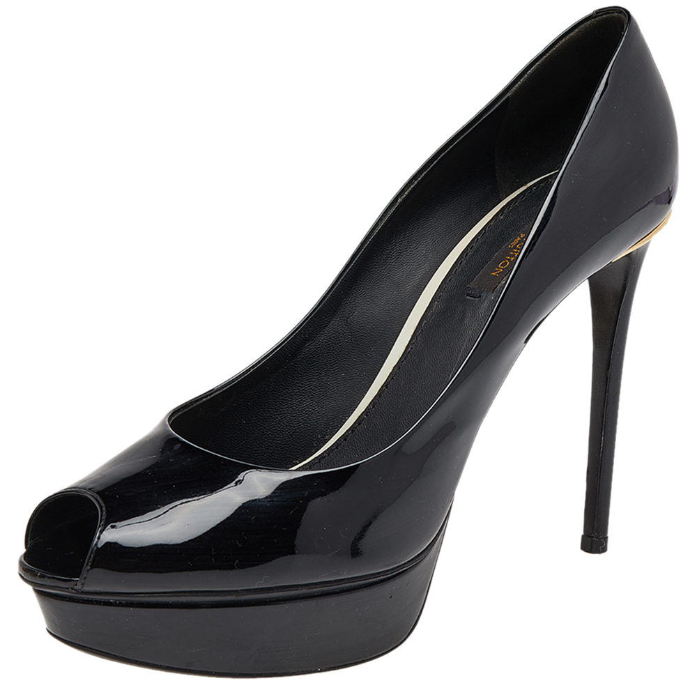 Look smart and stylish in this pair of Eyeline pumps designed from patent leather. Unleash the smart look with this pair of shoes designed by Louis Vuitton. The pair is styled with platforms high heels and peep toes. Ideal for formal events this pair is available in the classiest shade of black and is complete with gold tone accents engraved with the brand details at the counters.