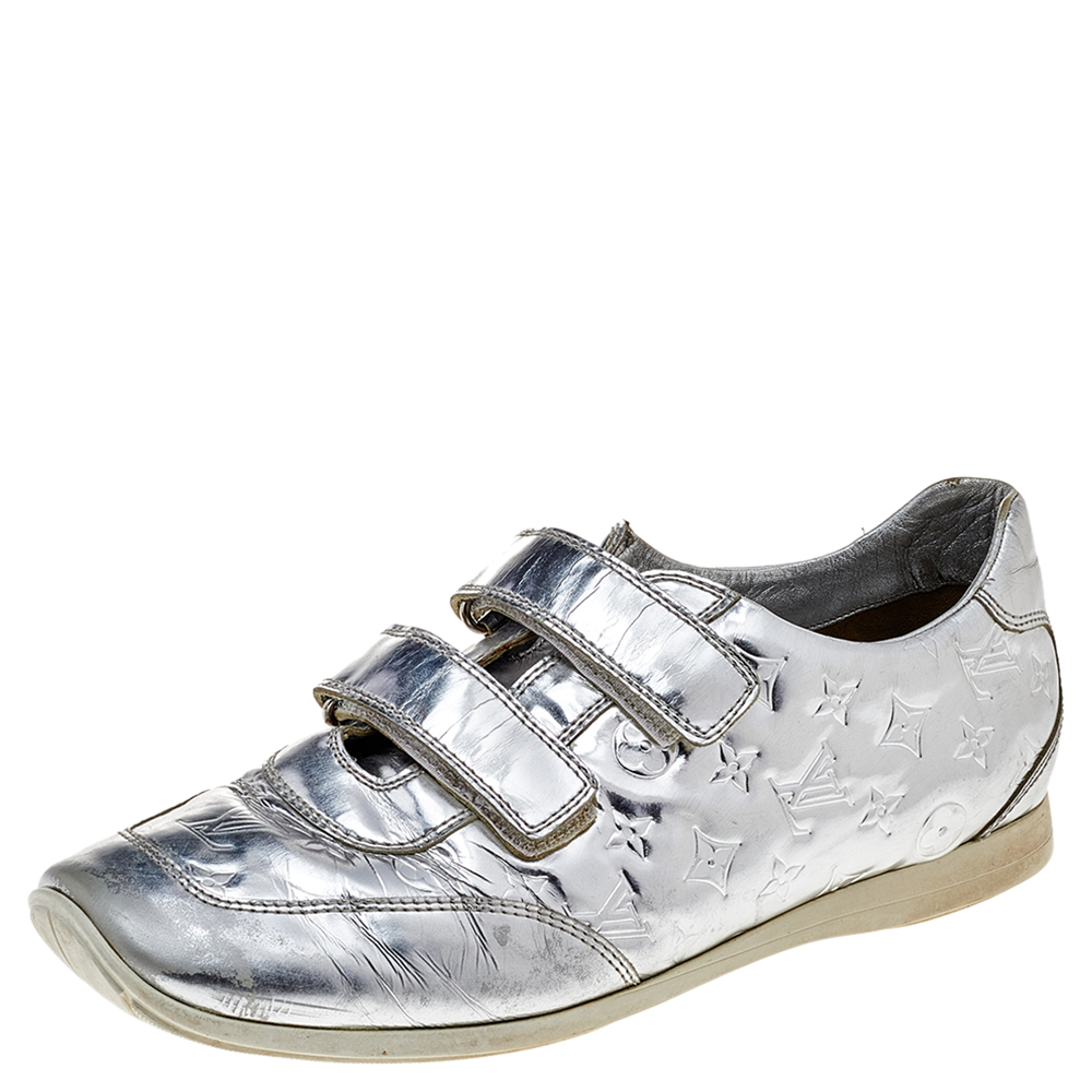 Kick your casual look up a notch with these Mirror tennis shoes by Louis Vuitton. Crafted from metallic leather they feature the signature Louis Vuitton monogrammed leather details and round toes. They come equipped with velcro fastened fronts. The comfortable leather lined insoles carry brand details.