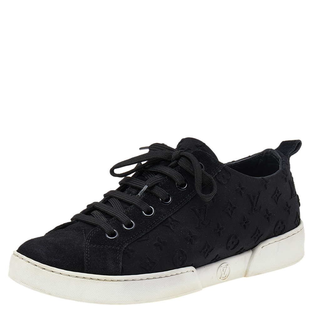 Coming in a classic low top silhouette these Louis Vuitton sneakers are a seamless combination of luxury comfort and style. They are made from monogram fabric in a black shade. These sneakers are designed with logo details on the counters laced up vamps and comfortable insoles.
